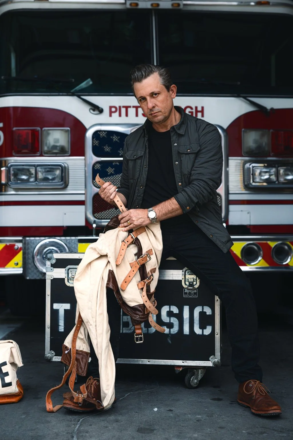 Lee Terbosic with his straitjacket and ESCAPE case in front of a Pittsburgh firetruck