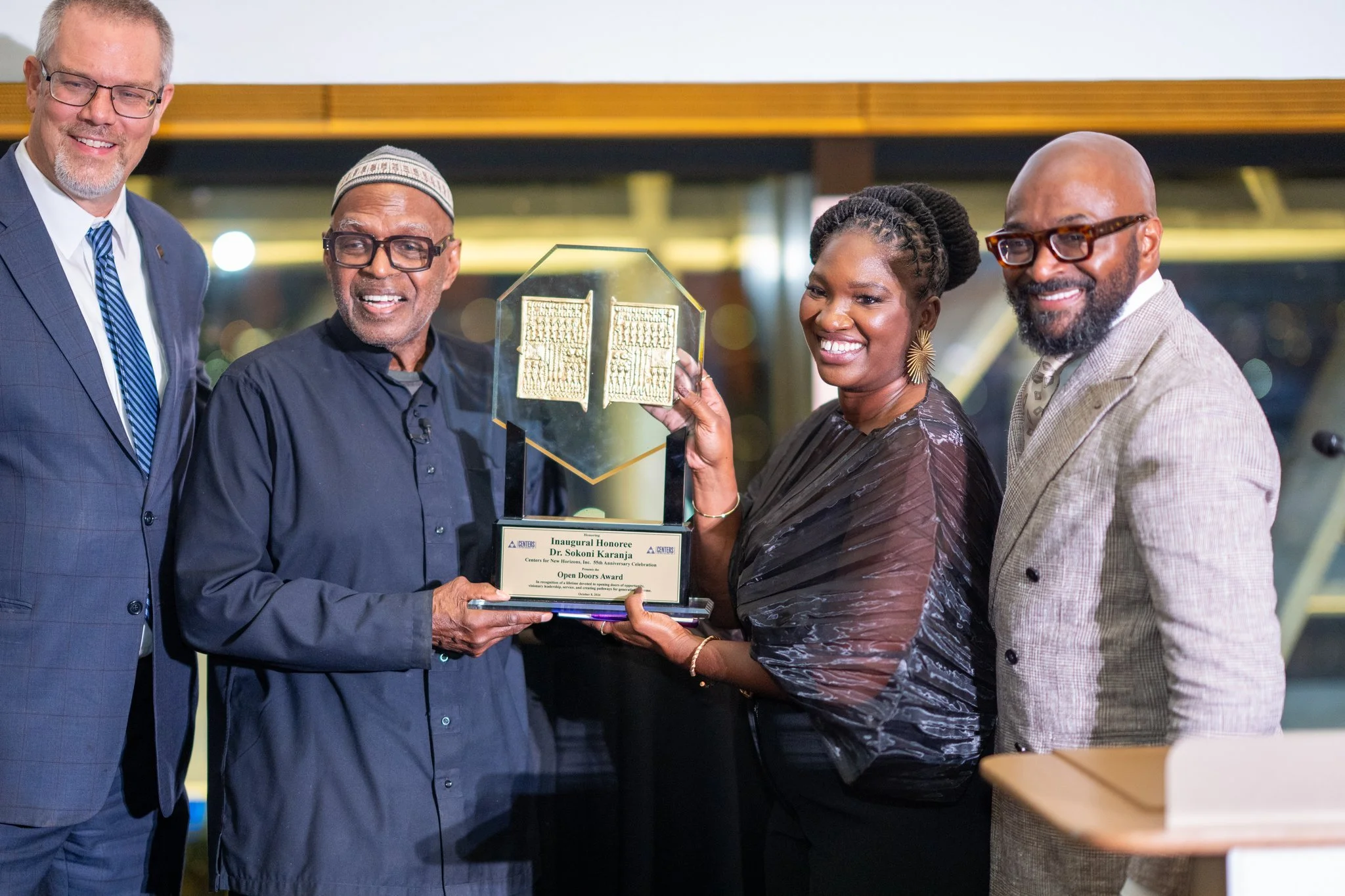 Centers CEO Lakisha McFadden presenting Dr Sokoni Karanja with an award
