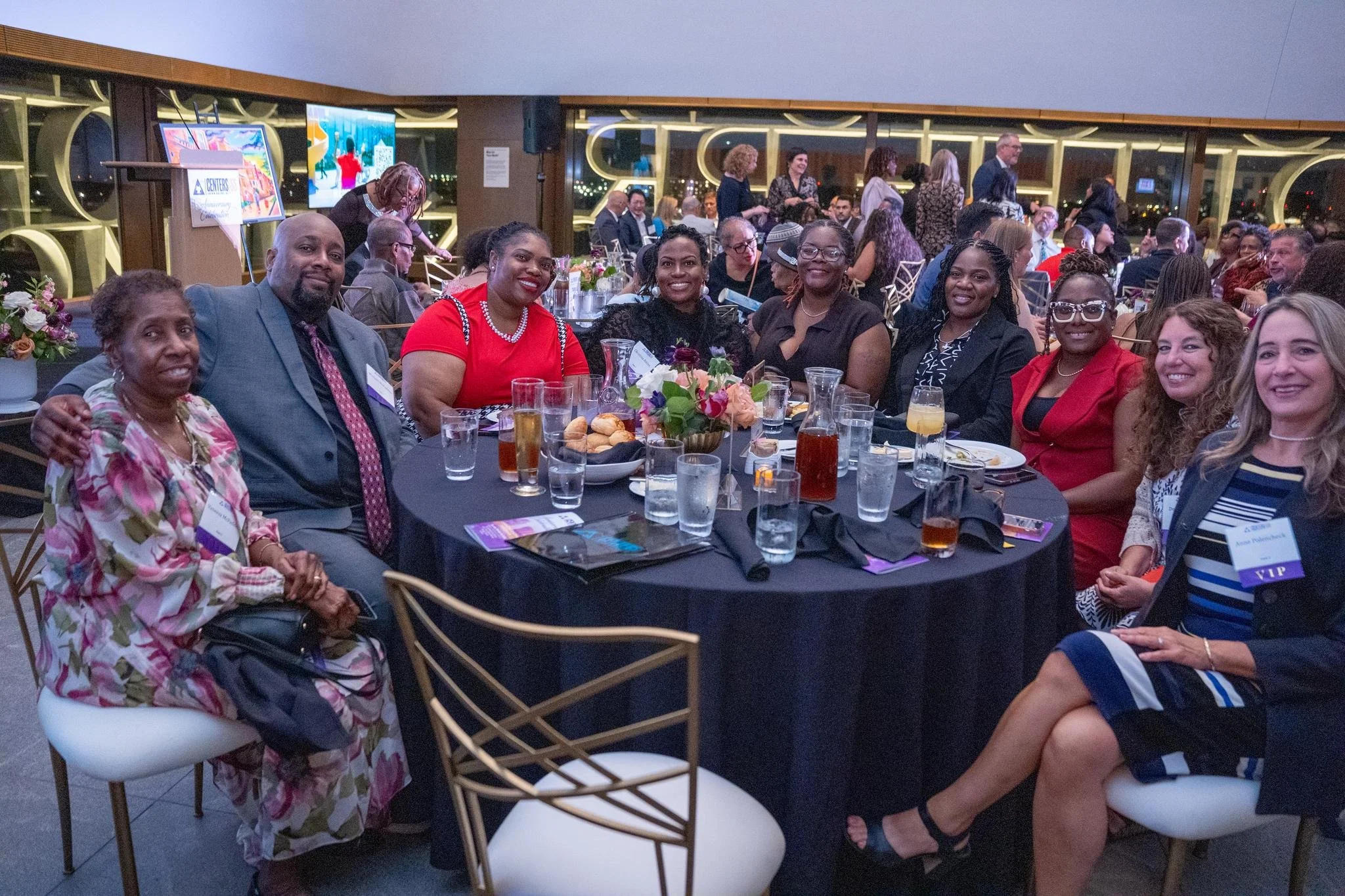Event guests posing for a photo around their table