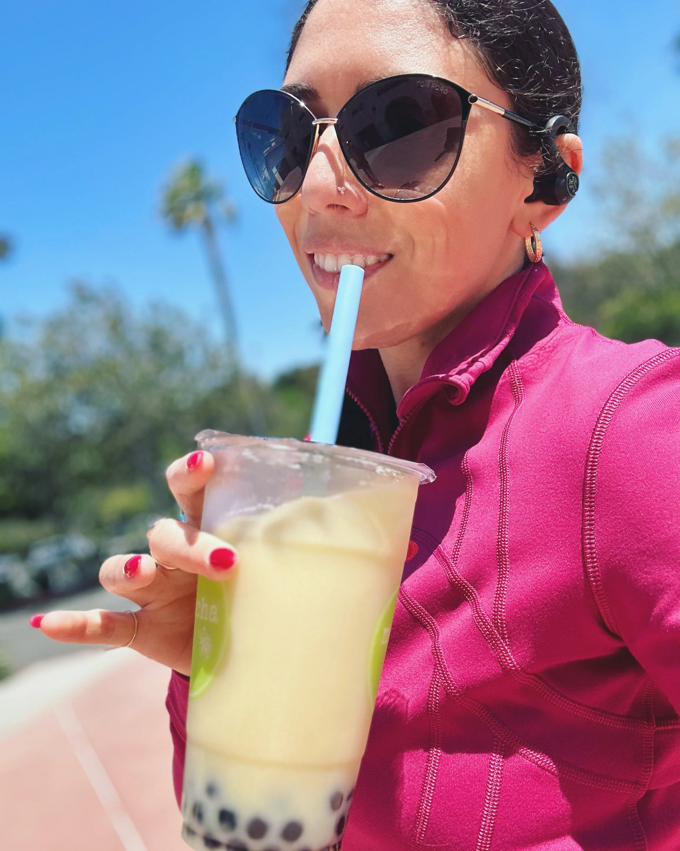 woman in yoga attire drinking boba