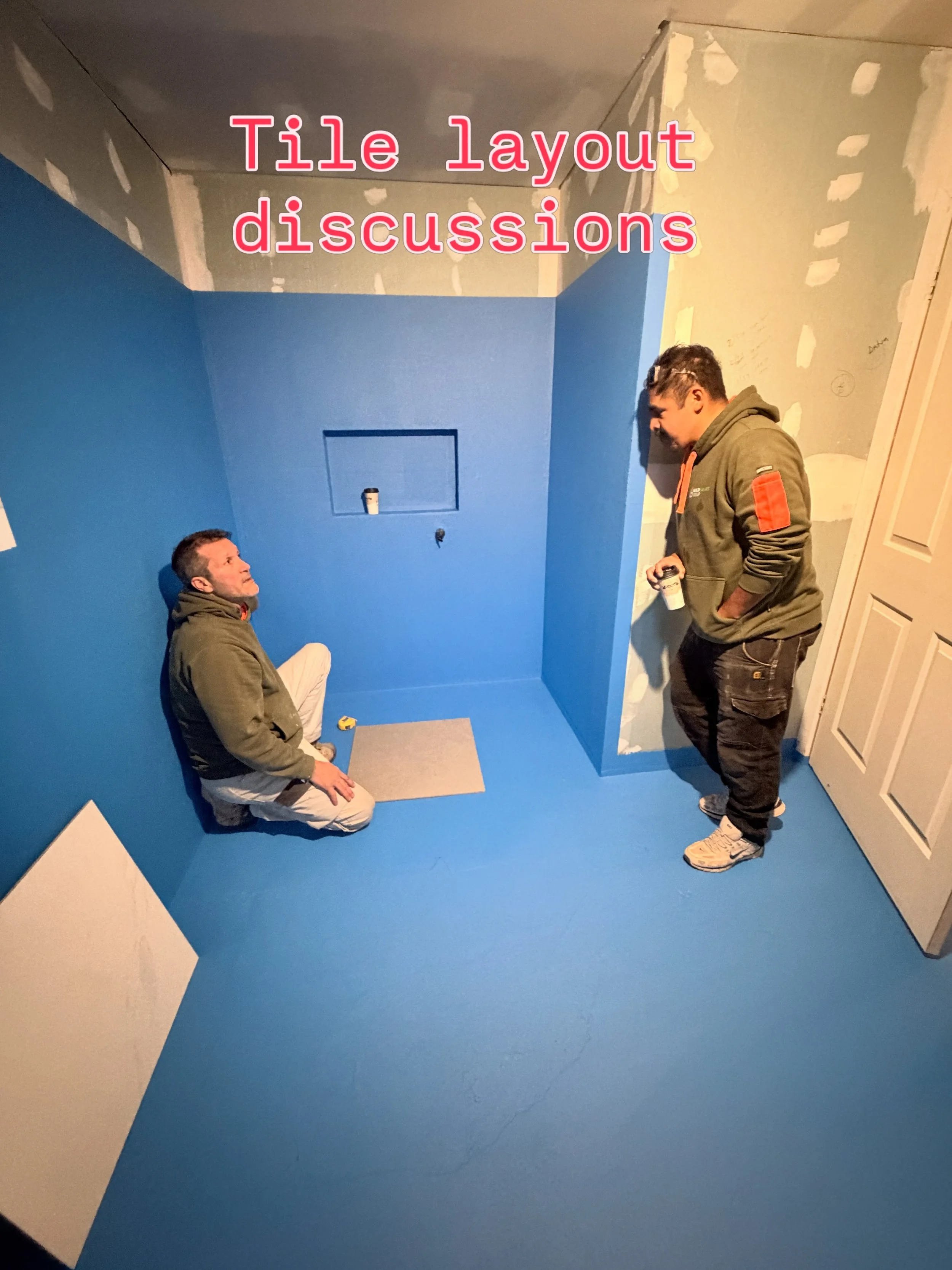 Tony and Vince setting out our shower and tile layout at our current job.