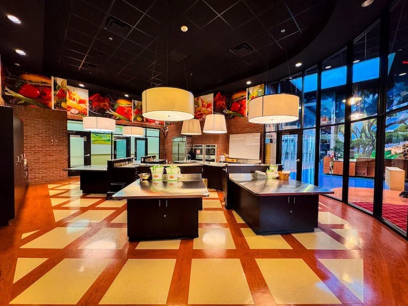 The incredibly modern cooking area at Novastar Academy, with multiple chef-sized tables for prepping food, 4 ovens, and ample cabinet space all in a brightly lit classroom. Culinary Arts is an elective open to homeschool students.