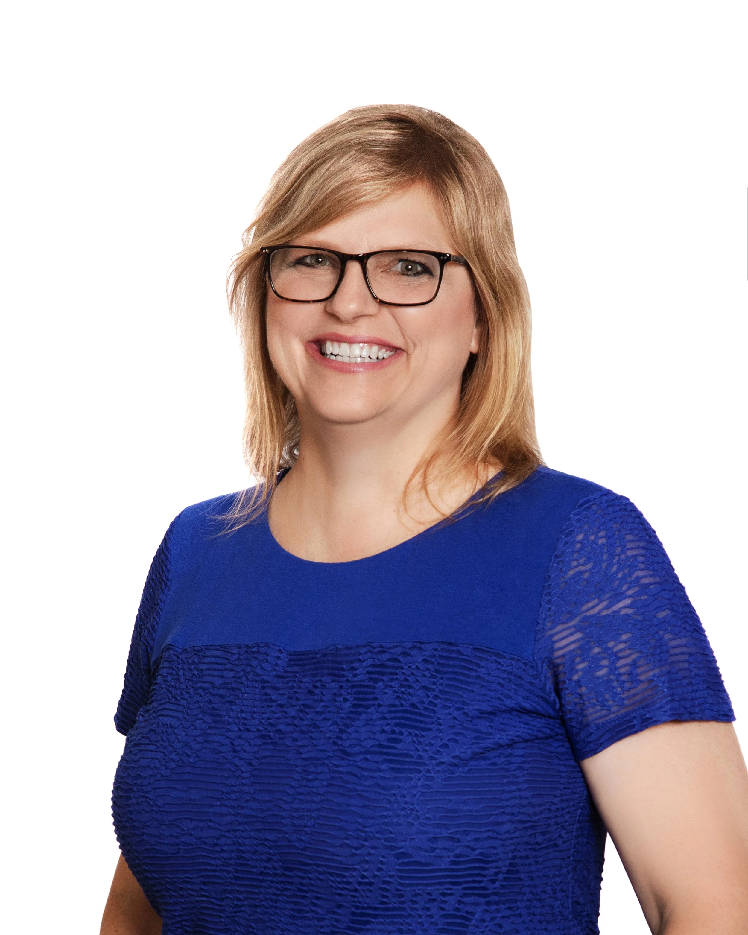 A woman with shoulder-length blond hair, wearing black glasses and a blue textured short-sleeve top, smiling against a white background.
