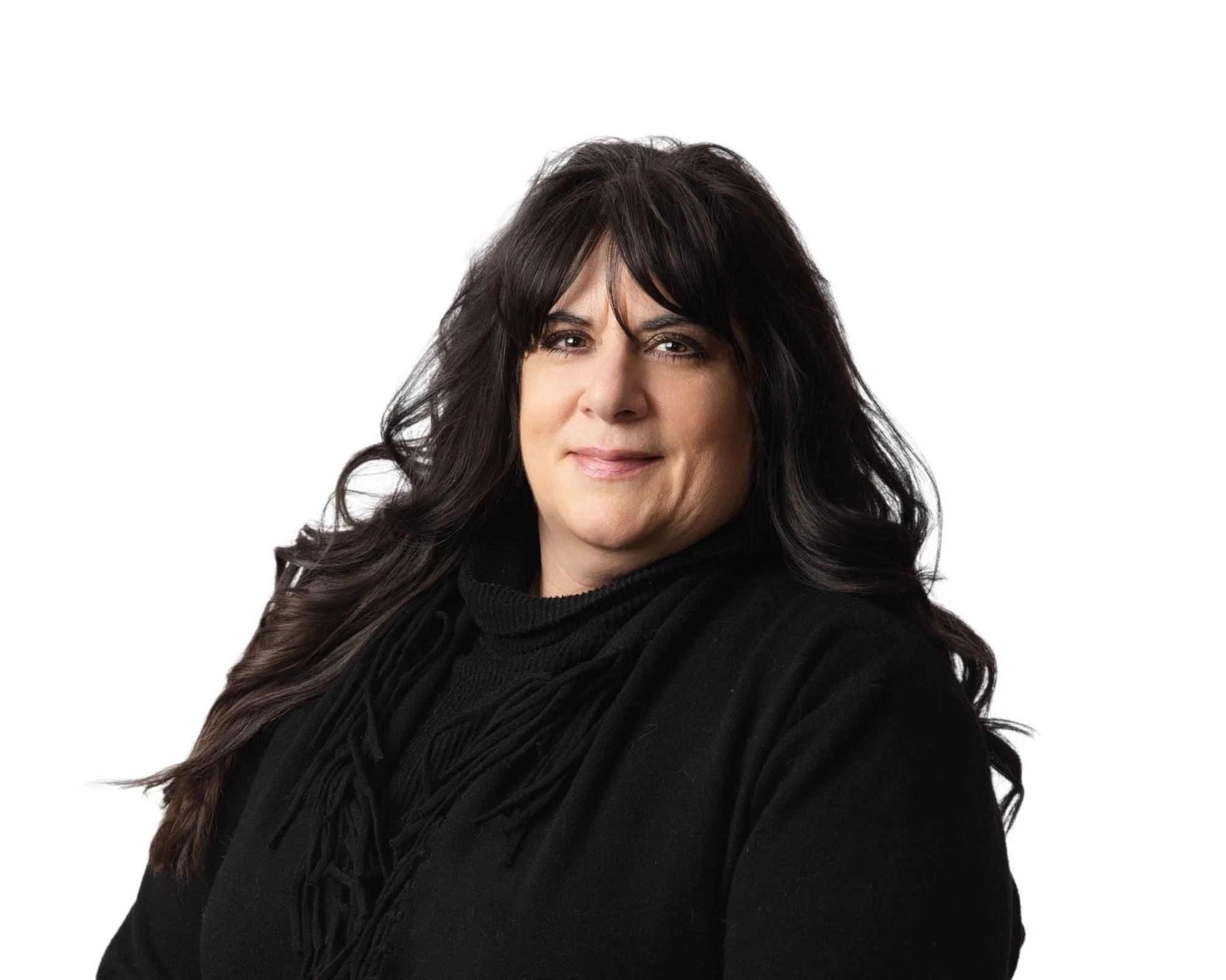 A woman with long black wavy hair wearing a black turtleneck and smiling at the camera