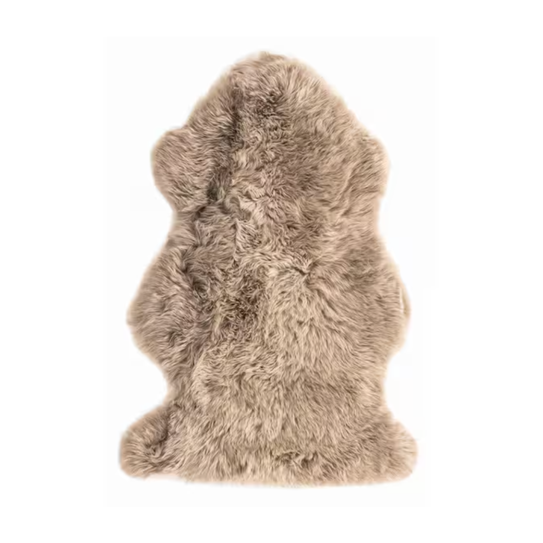 A beige, fluffy fur rug or throw.