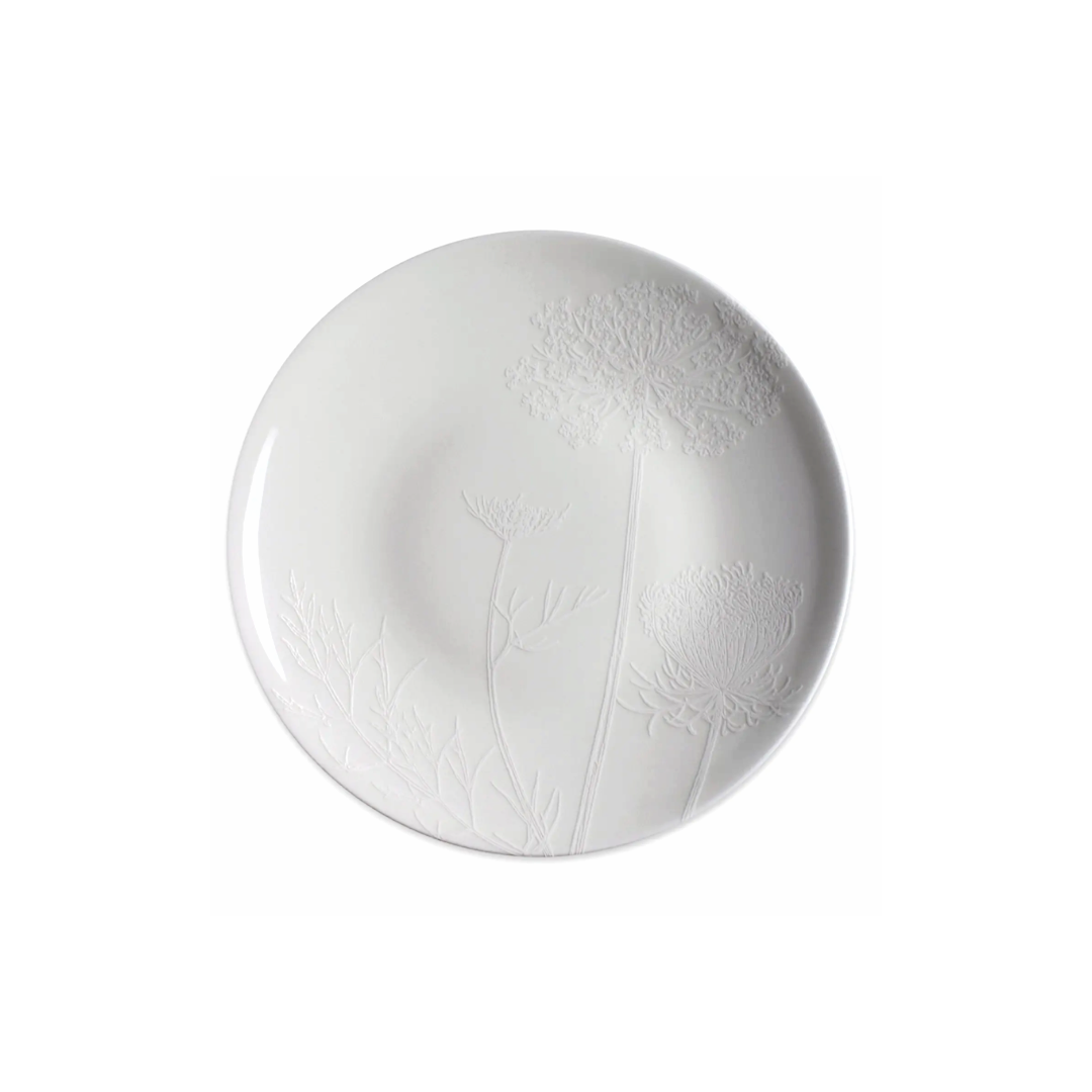White ceramic plate with embossed botanical floral design.