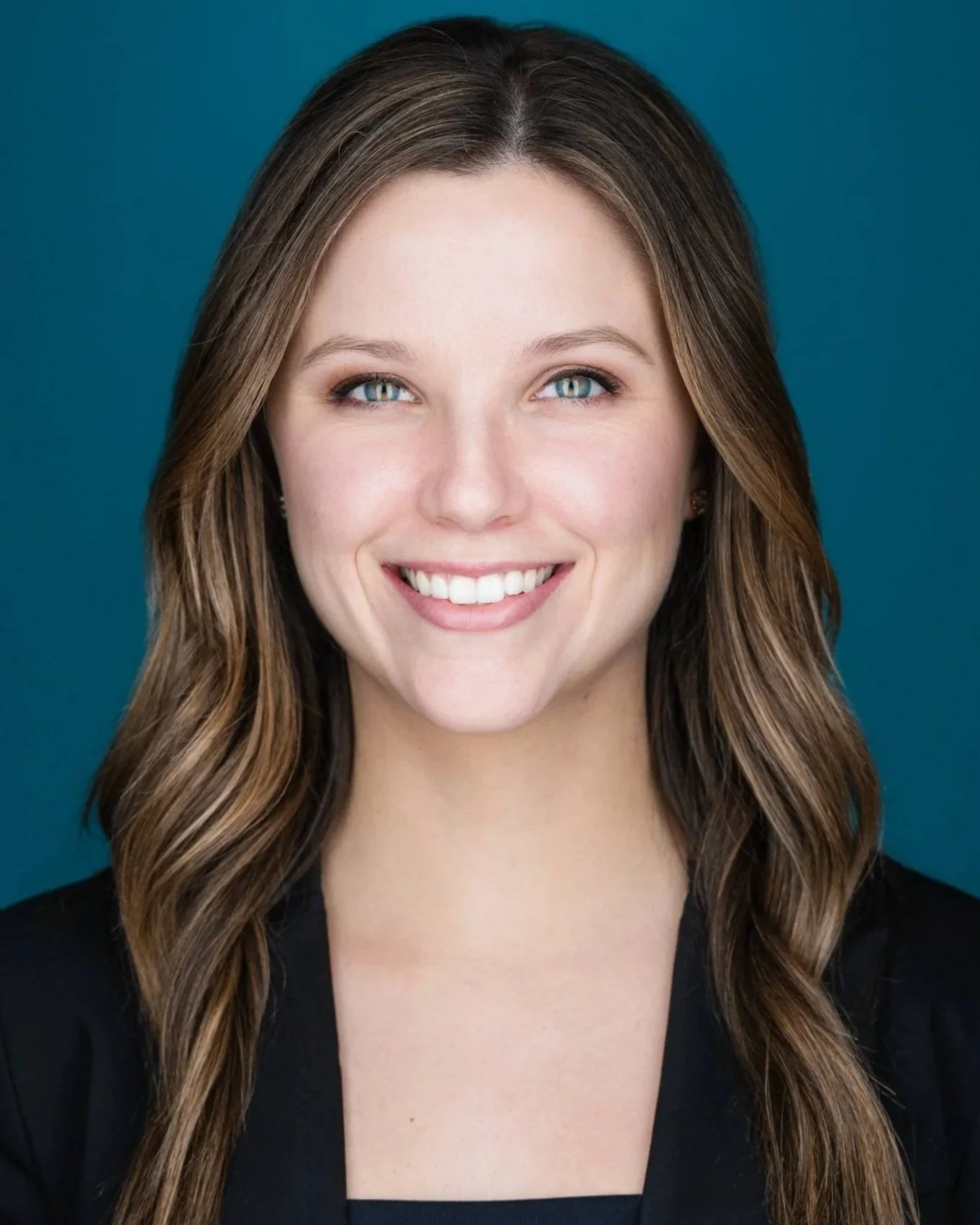 Vancouver corporate headshot of a professional smiling on a blue background