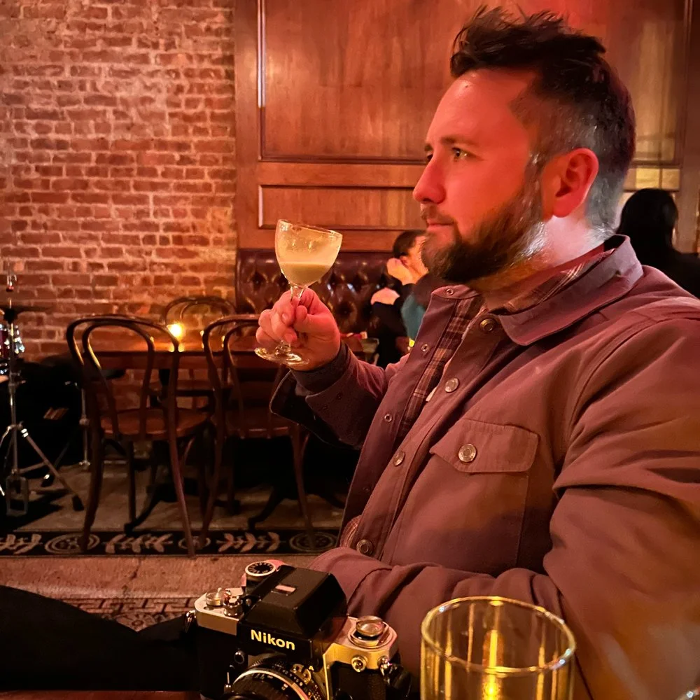 Photo of Simon Rochfort drinking a cocktail