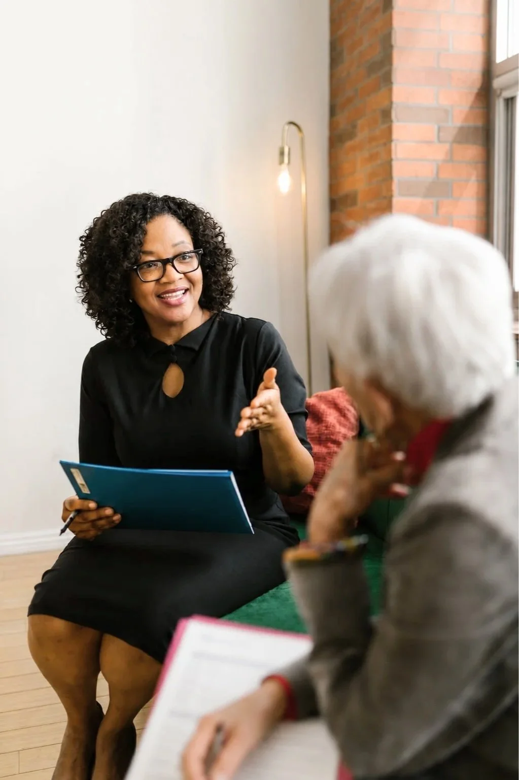 Case management professional helping a client navigate Medicare benefits, care coordination, and community resources with compassionate, personalized support at Renewing Hope LLC.
