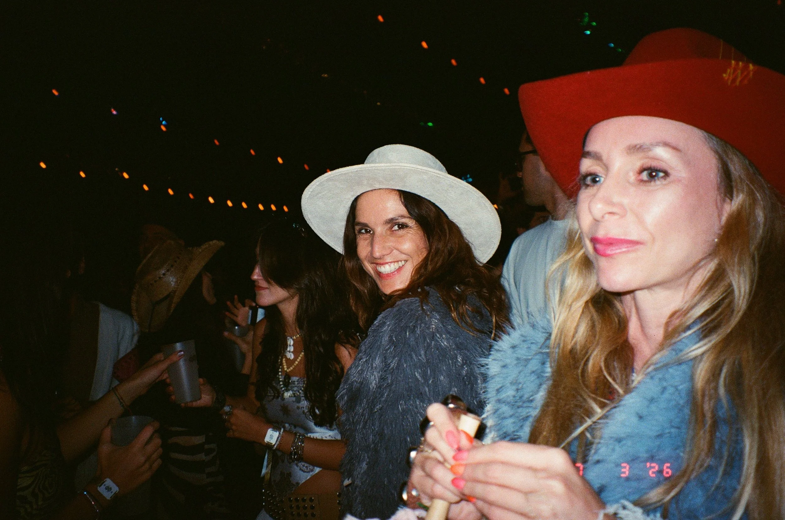 Women wearing large hats and festival clothing at Amarás Oaxaca Experience 2026.