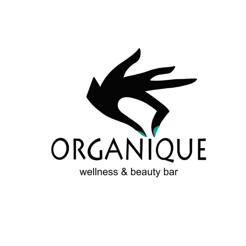 Logo for Organique Wellness & Beauty Bar featuring a black stylized hand with teal fingertips above the text.