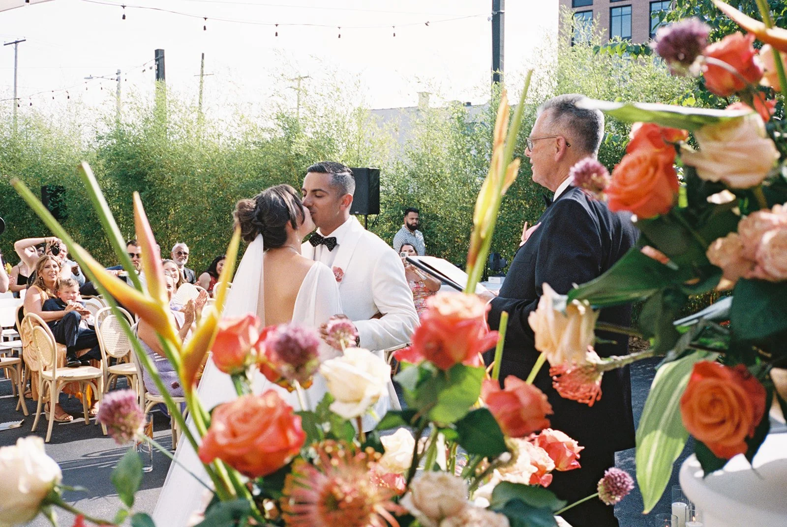 Gordon Green Cleveland ceremony framed through florals during wedding moment.