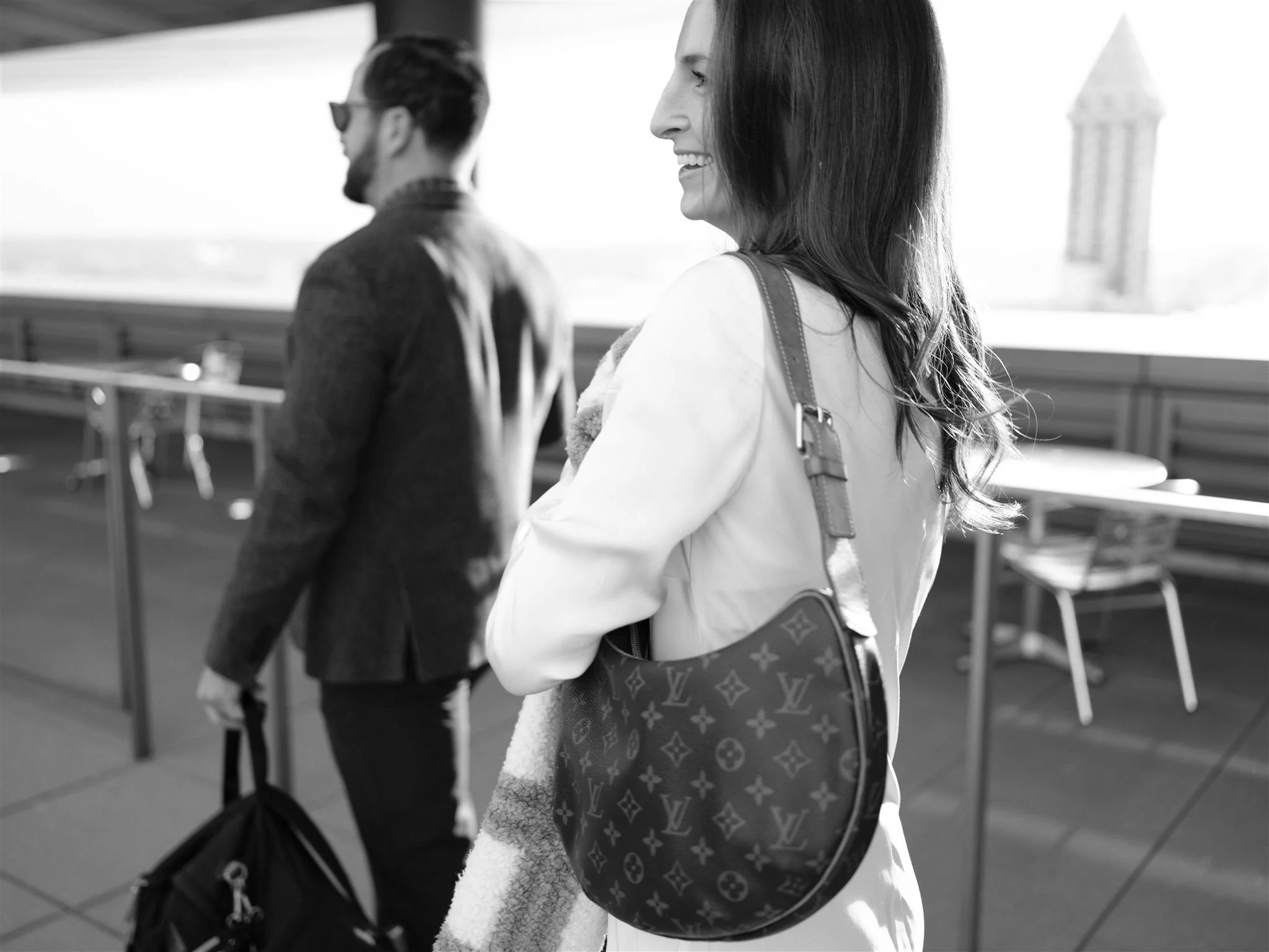 Couple walking together on the rooftop of the Seattle Municipal Courthouse, captured candidly in black and white during an intimate courthouse wedding day.
