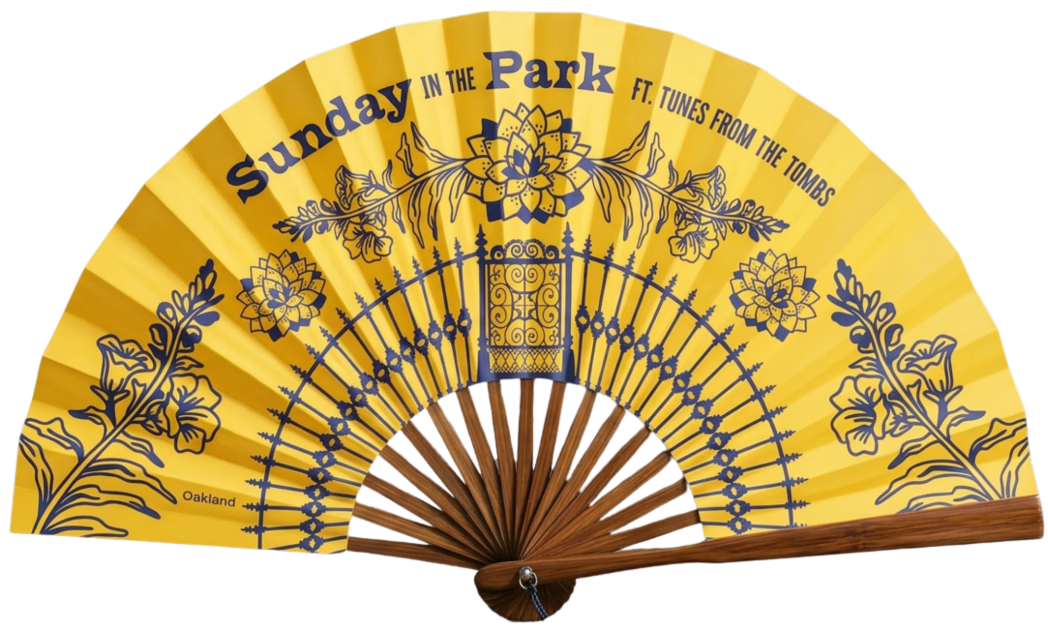 Yellow folding hand fan with an ornate dark blue floral and gate design, labeled 'Oakland' at the bottom, displayed against a black background.