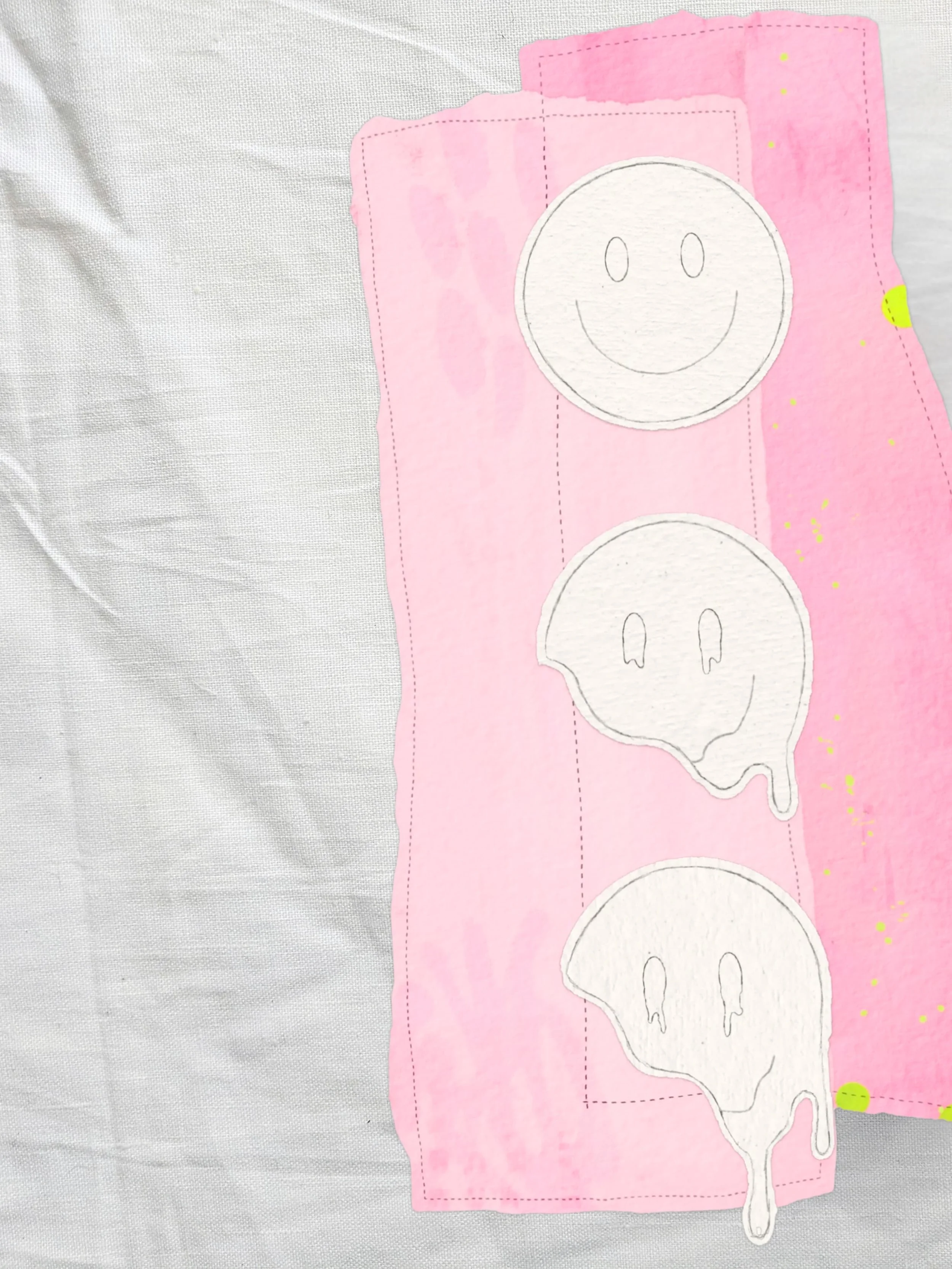 Pink paper with printed smiley face faces and ghost images, on a wrinkled white background.