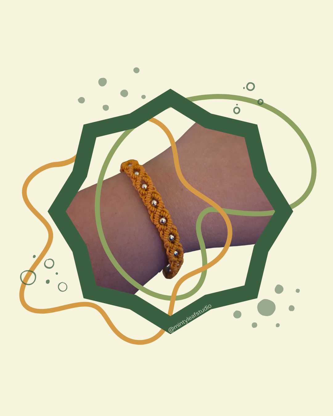 A yellow macrame bracelet with shiny silver beads worn on a person's wrist, surrounded by abstract green and orange lines and shapes.