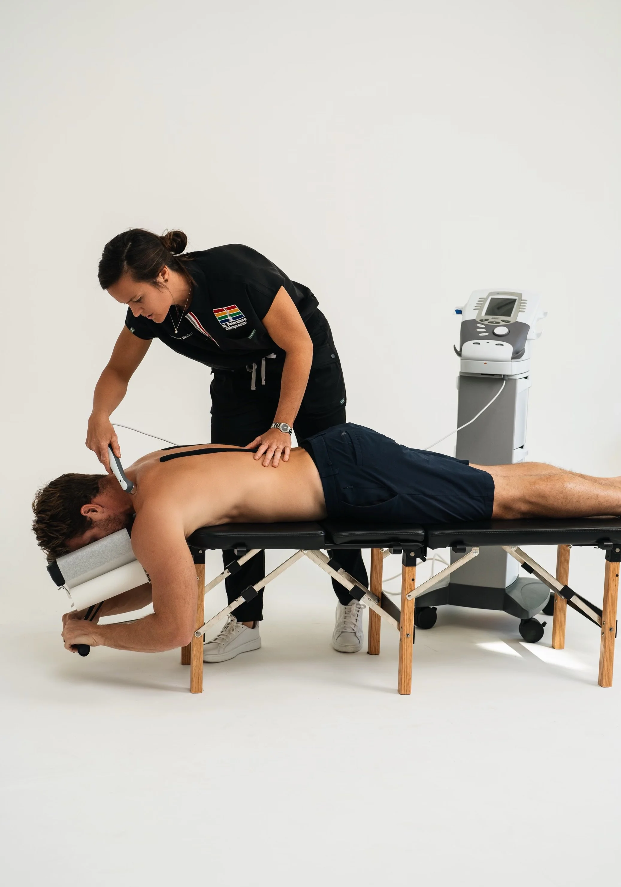 Doctor Bryane Heaberlin ultrasound therapy and neuromuscular electrical stimulation on neck at St. Petersburg Chiropractic Florida