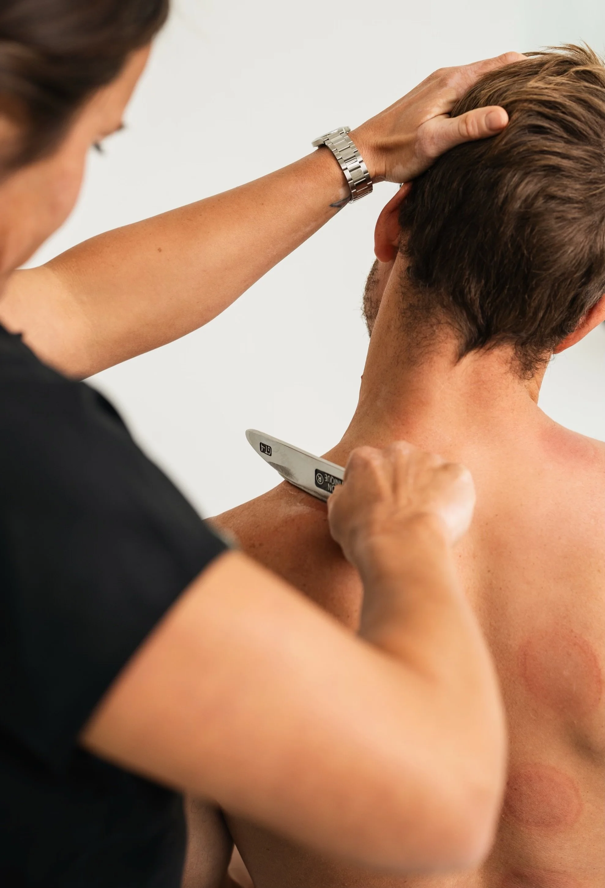 Doctor Bryane Heaberlin Instrument Assisted Soft Tissue Mobilization on neck at St. Petersburg Chiropractic Florida
