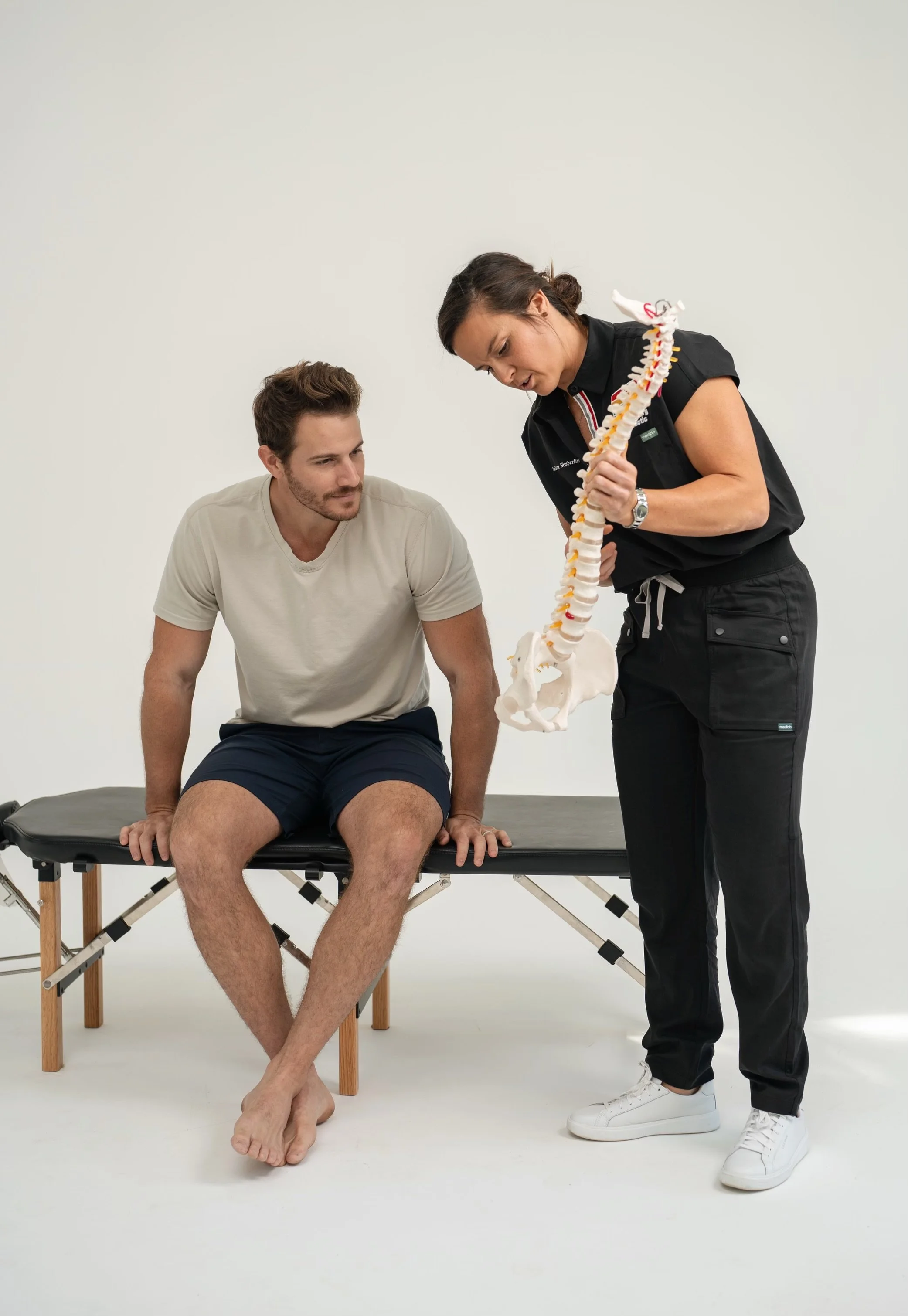 Doctor Bryane Heaberlin showing spine to patient  at St. Petersburg Chiropractic Florida