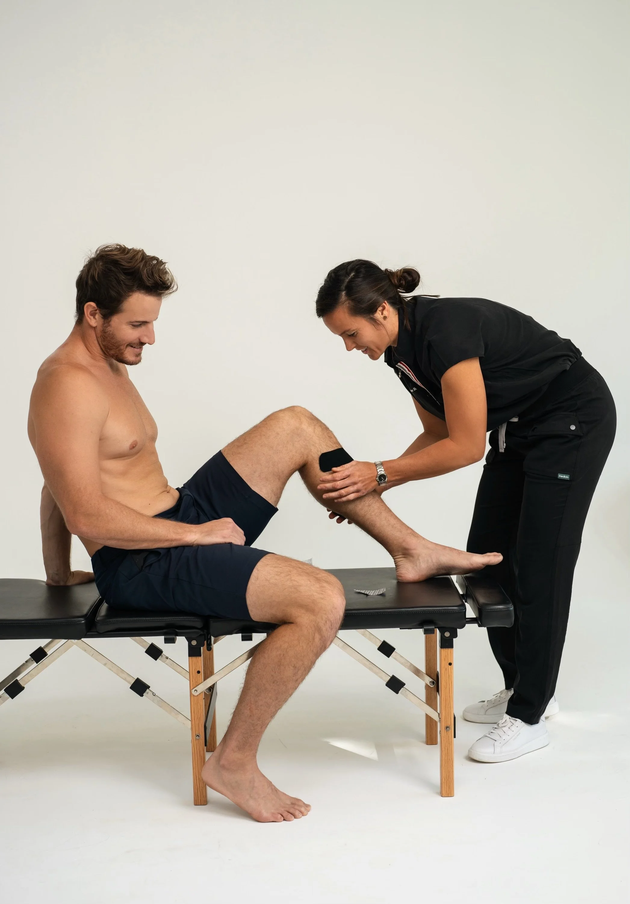 Doctor Bryane Heaberlin kinesiology tape (KT tape) on knee at St. Petersburg Chiropractic Florida