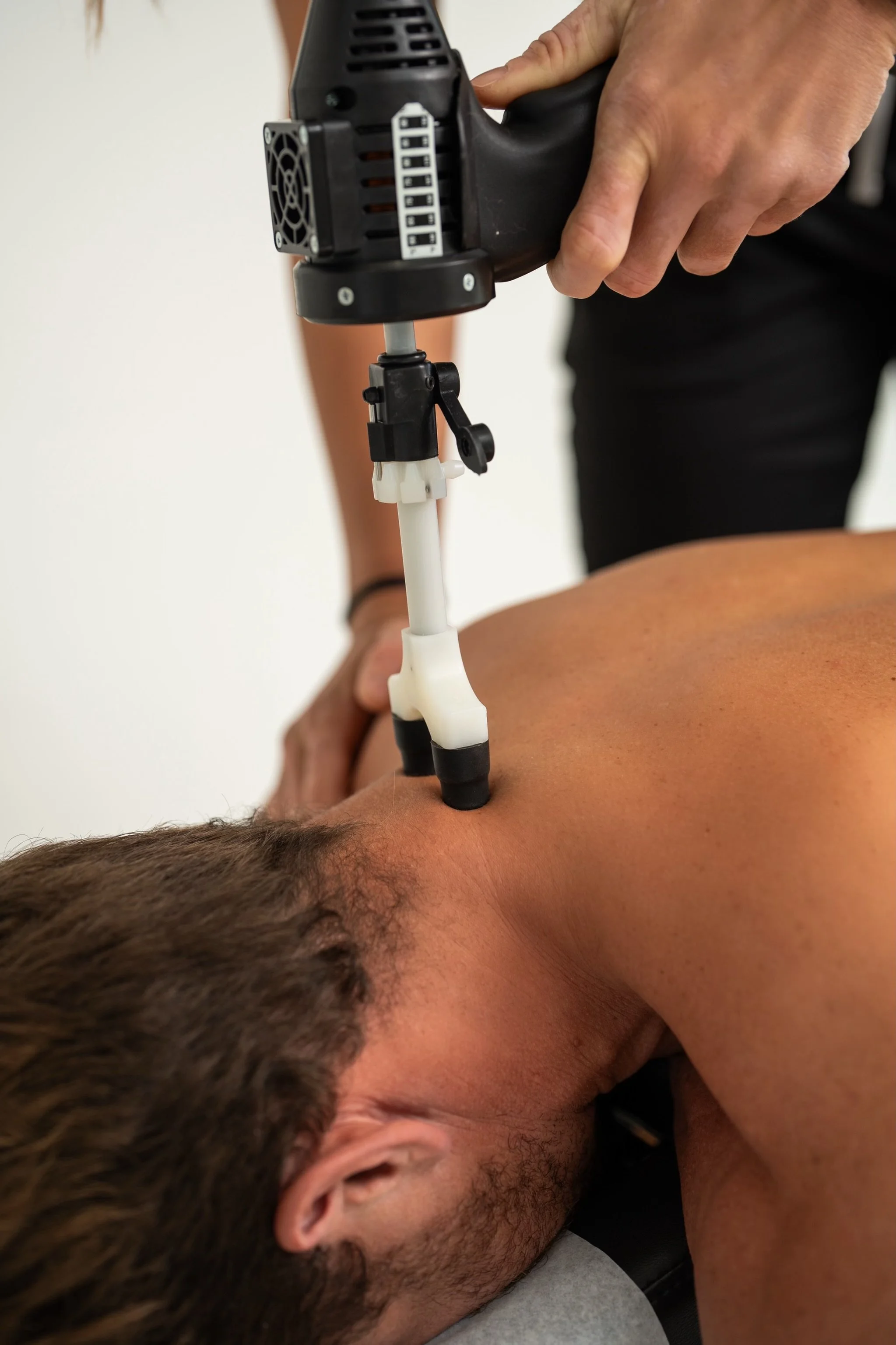 Doctor Bryane Heaberlin instrument assisted soft tissue mobilization on back at St. Petersburg Chiropractic Florida