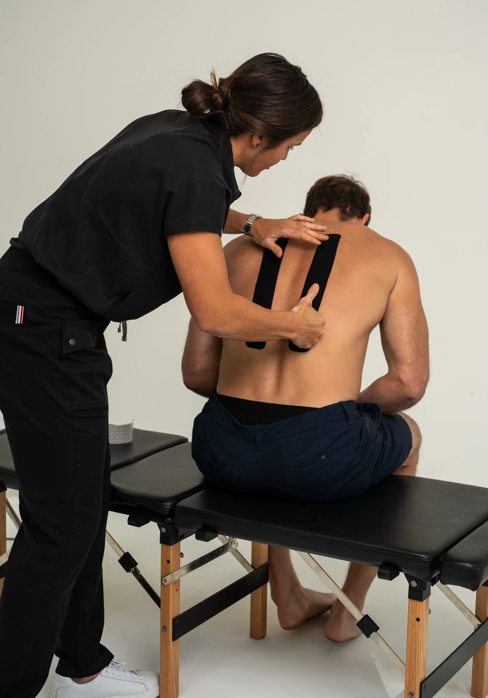 Doctor Bryane Heaberlin kinesiology tape (KT tape) on back at St. Petersburg Chiropractic Florida
