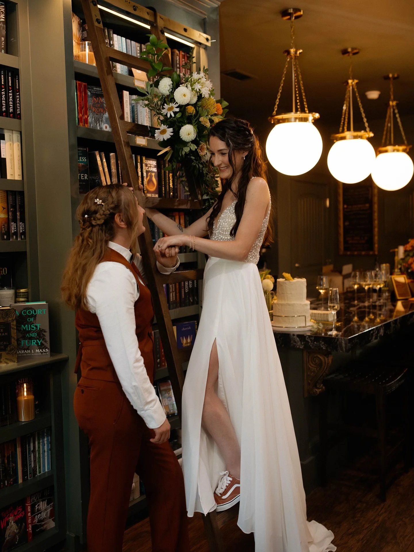 Some love stories feel like they&rsquo;re written in the stars, theirs was written among the shelves. 📖✨
Brittaney and Rachelle tied the knot in one of the most magical settings we&rsquo;ve ever seen &mdash; The Archive in Mt. Pleasant &mdash; surro