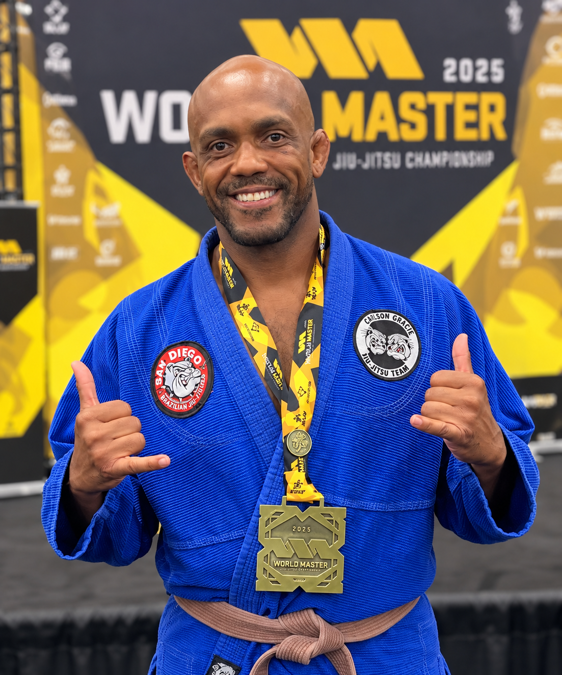 HYPE Performance coach displaying a Brazilian Jiu Jitsu competition medal.