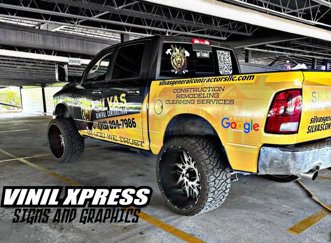 A black and yellow pickup truck with custom vinyl wrap advertising Silvas General Contractors, including services like construction, remodeling, and cleaning. The truck features large tires, custom rims, and multiple decals, including a lion crest, a QR code, and a Google review badge, parked in an indoor parking garage.