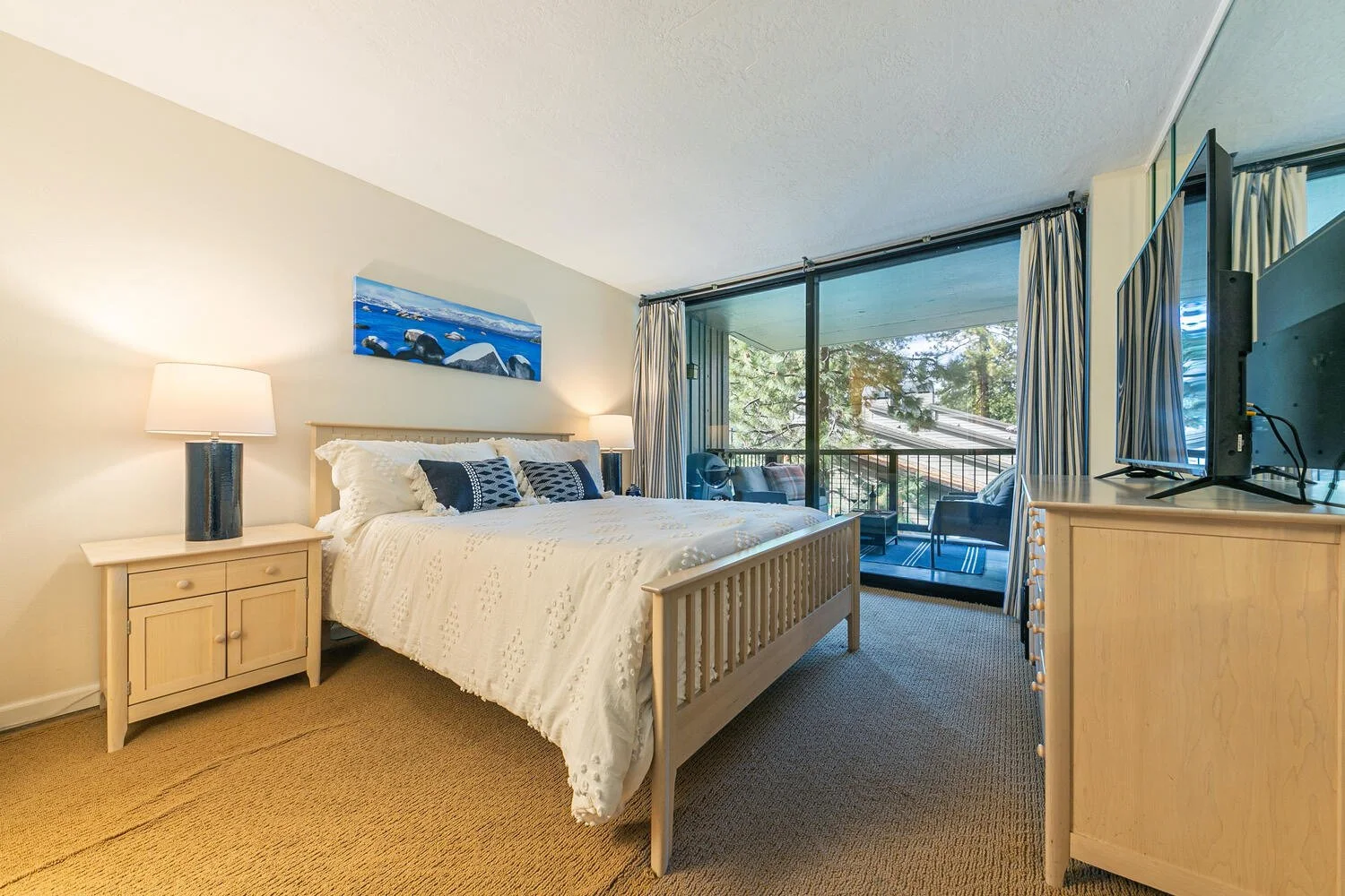 main bedroom with light wood furniture and sliding doors