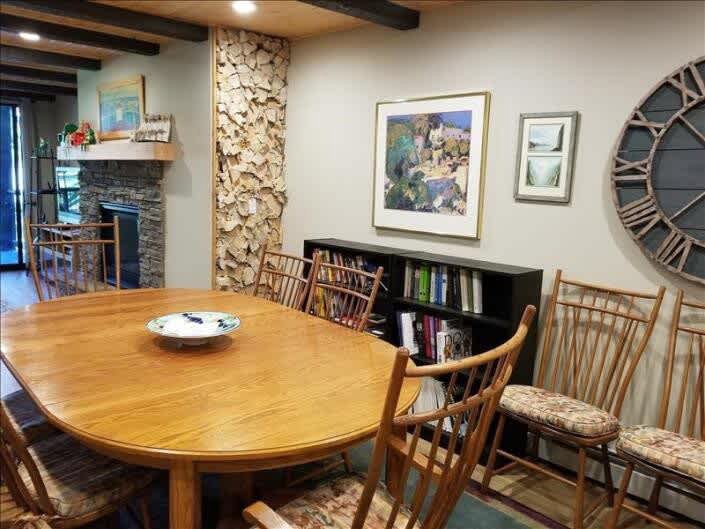 dining area showing wood floor and table with 6 chairs, art on wall