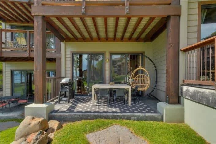 covered deck area with outdoor furniture and grill