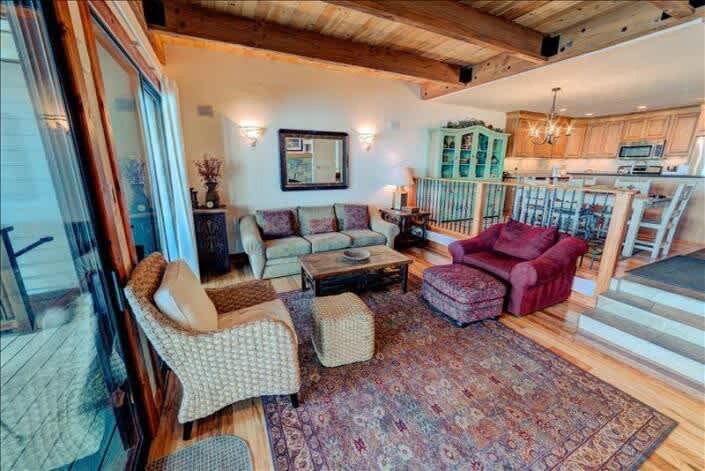 living room with chairs, sofa, sliding doors