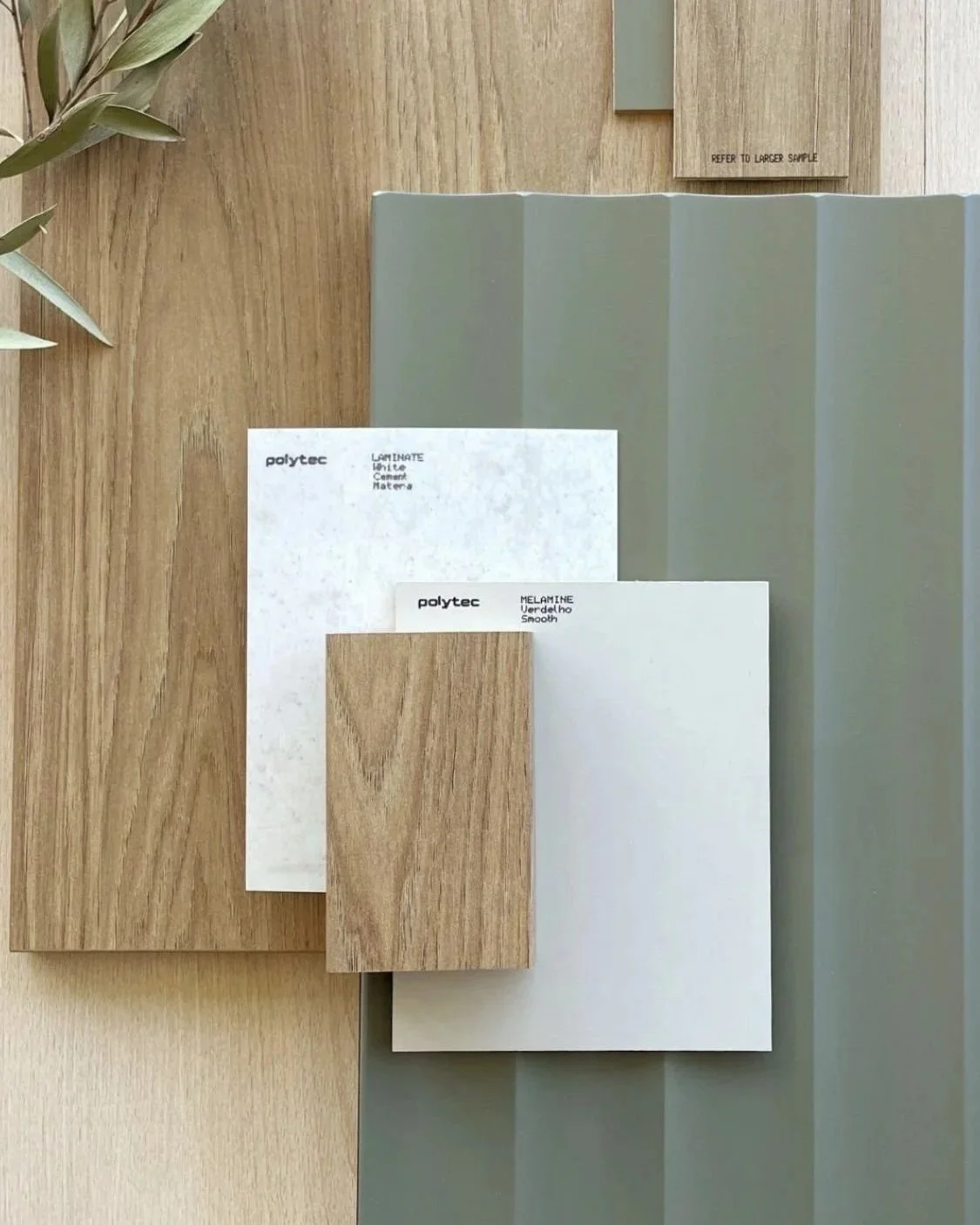 Samples of different building materials including wood, cement, and stone displayed on a table.