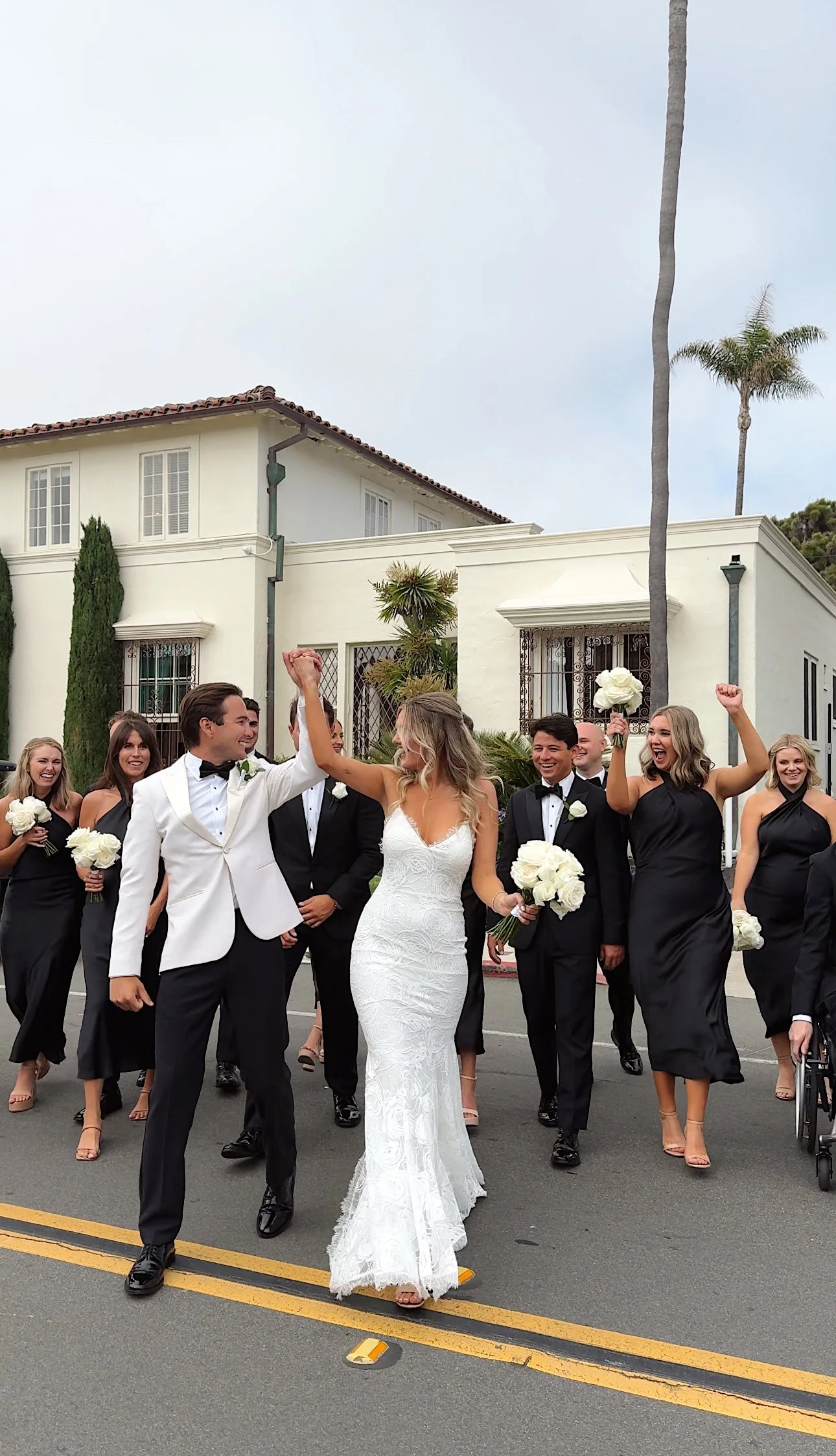 Bridal party crossing the street at the Darlington House in La Jolla, California captured by san diego wedding content creator who captures behind-the-scenes wedding videos.