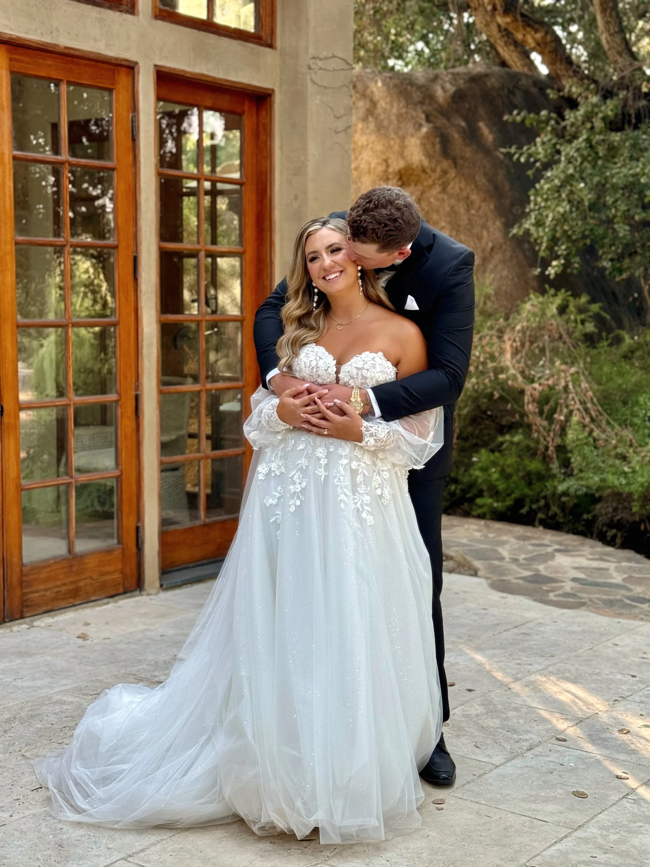 bride and groom hugging after the ceremony at Milagro Winery captured by san diego wedding content creator who captures behind-the-scenes wedding videos.