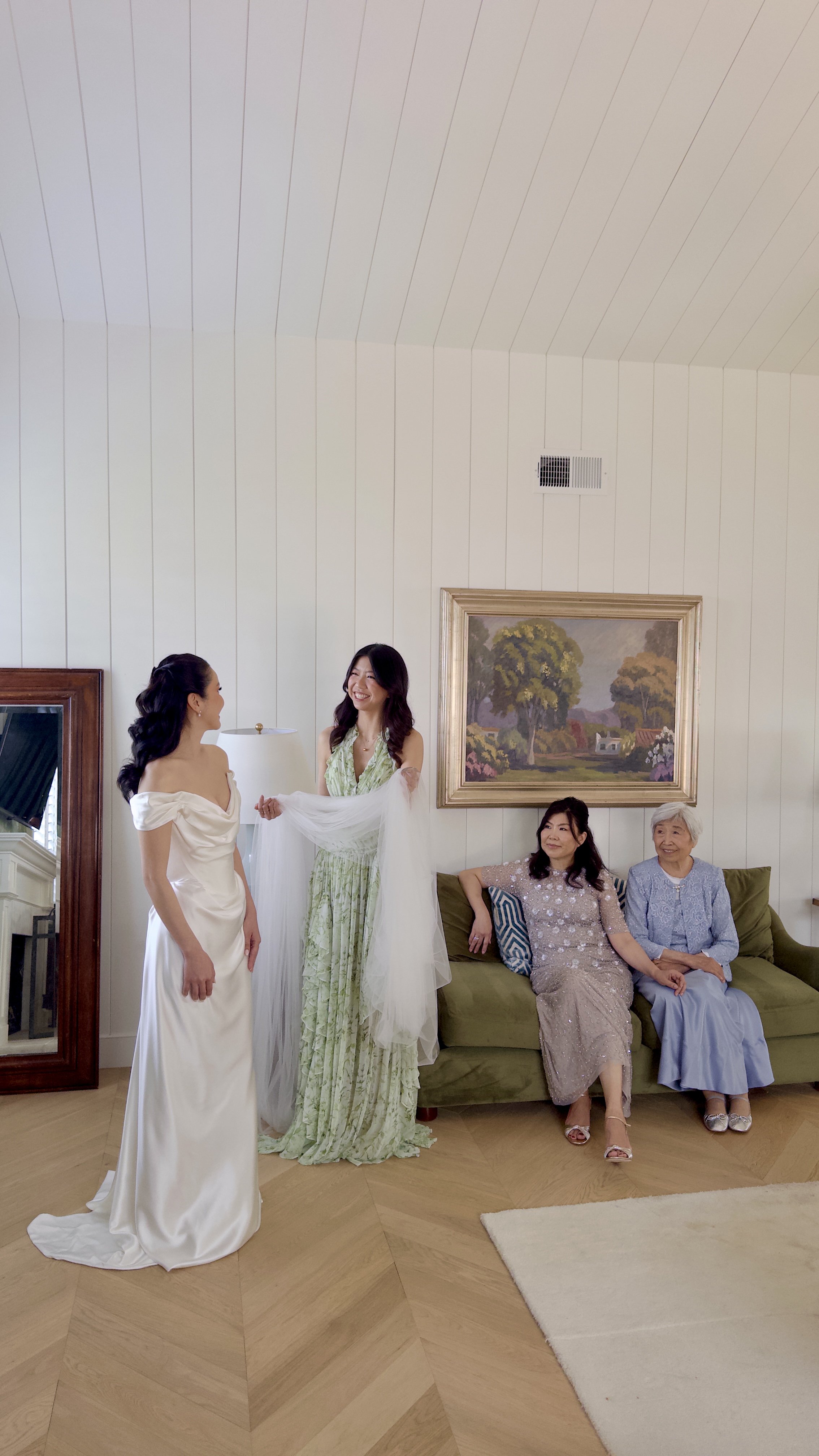 Bride getting ready with her first look with her sister, mom and grandmother at the Inn at Rancho Santa Fe captured by san diego wedding content creator who captures behind-the-scenes wedding videos.