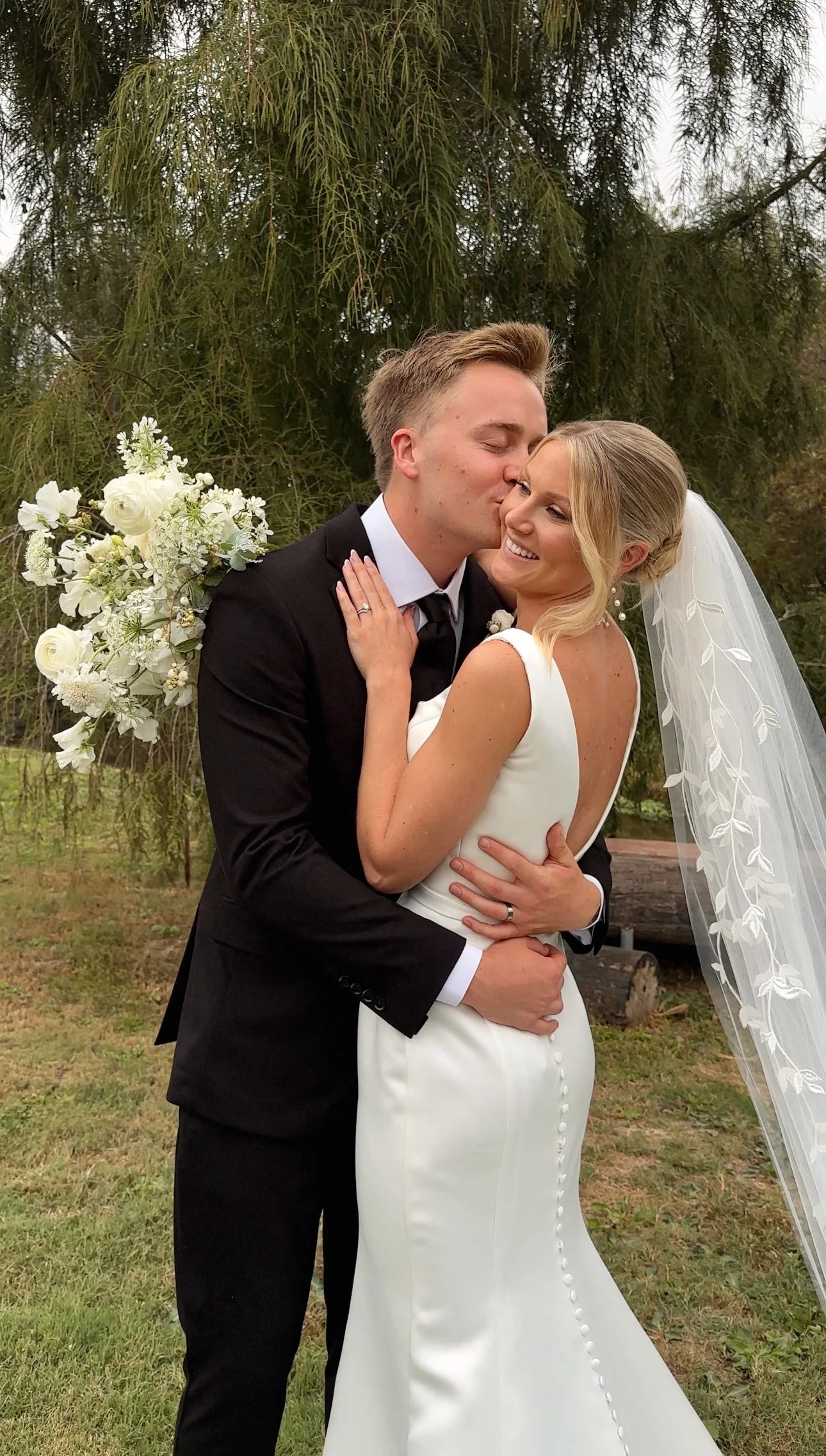 Bride and groom laughing together in Encinitas, California, captured by san diego wedding content creator who captures behind-the-scenes wedding videos.