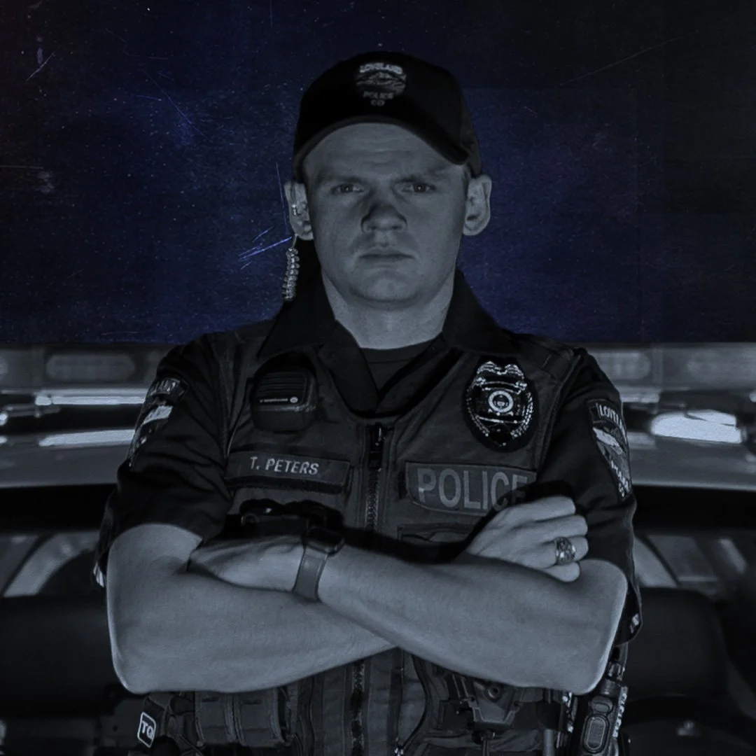 A police officer in uniform stands with arms crossed, wearing a cap and earpiece, in front of a space-themed background.