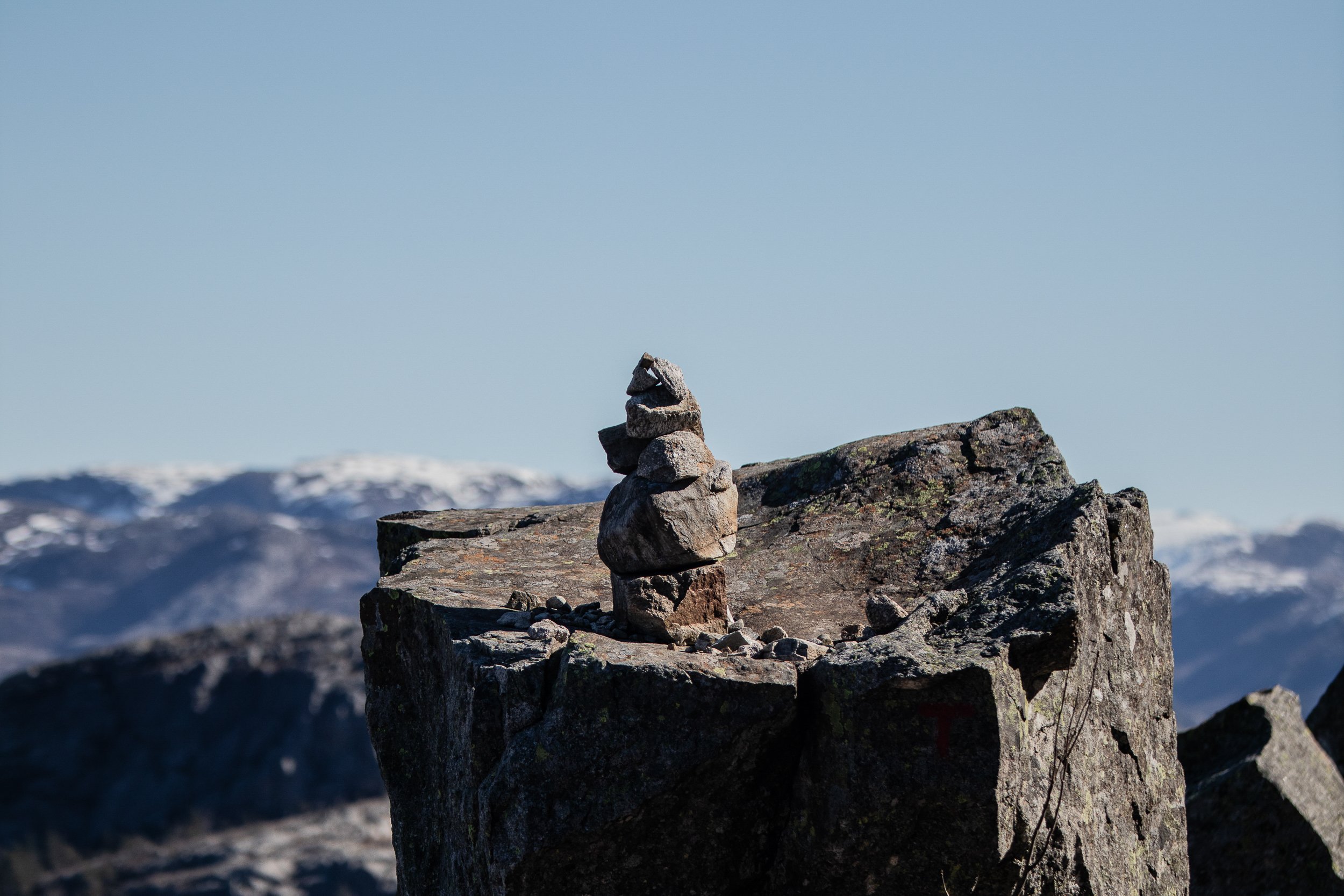 Stone towers built by people who reached the end of the Preikestolen (Pulpit Rock) trail, Norway, April 22, 2023