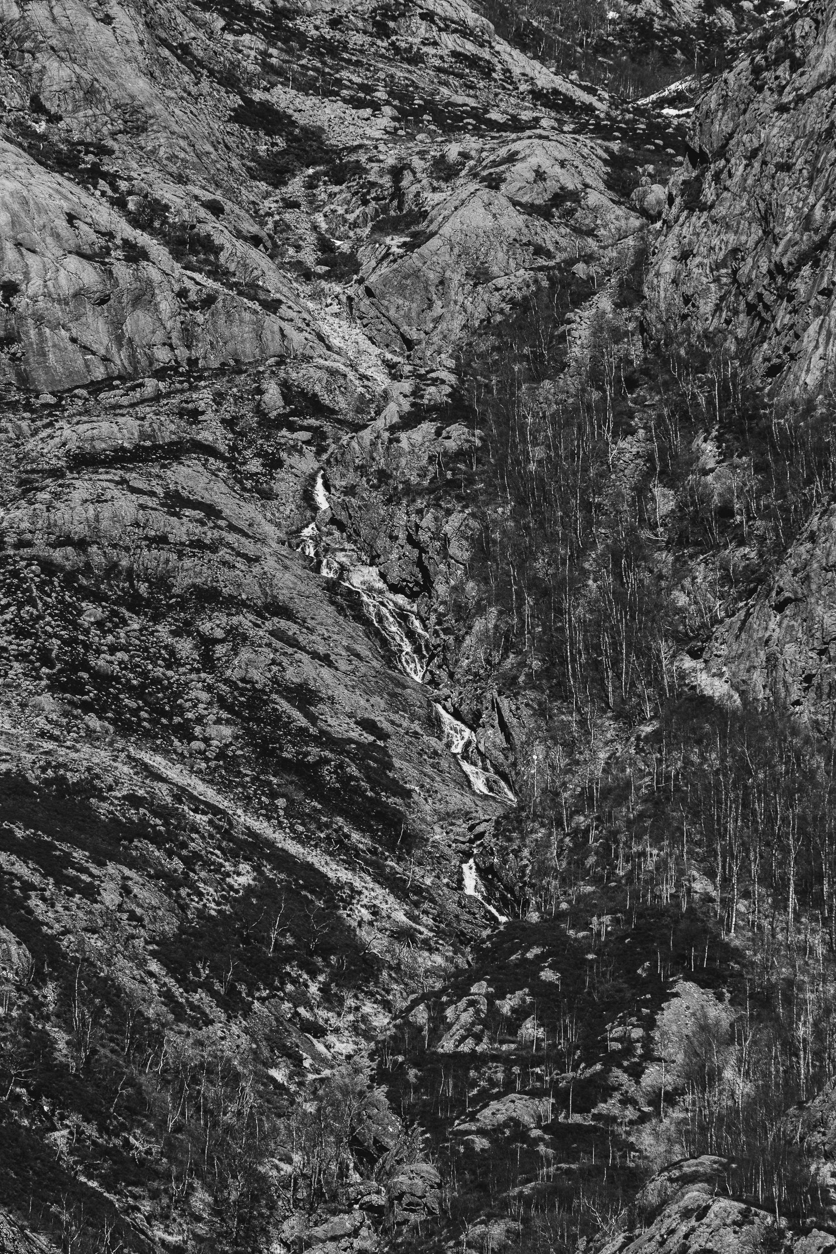 A small waterfall, visible while climbing the trail to Månafossen waterfall, Norway, April 21, 2023