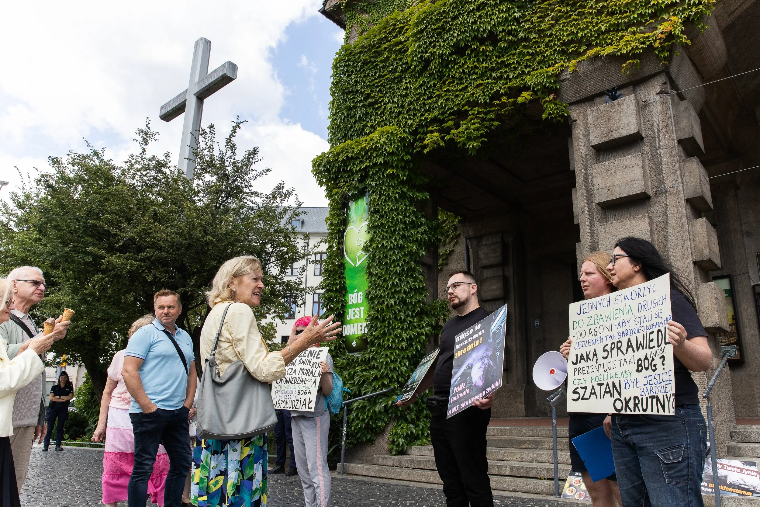 Protesters against animal slaughter and passers-by engaged in conversation, Szczecin, Poland, August 10, 2025