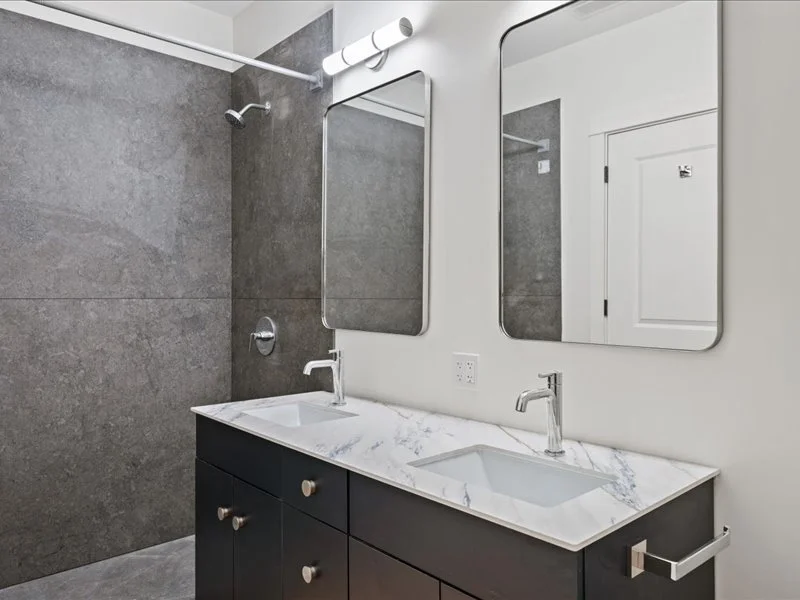 The Spinning Mill - Modern bathroom with walk-in shower, floating vanity, and large mirror