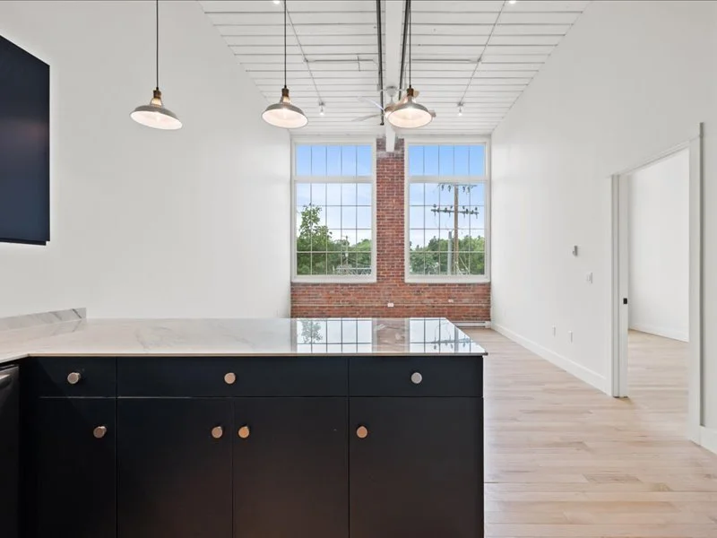 The Spinning Mill - Open kitchen and dining area with pendant lighting and hardwood flooring