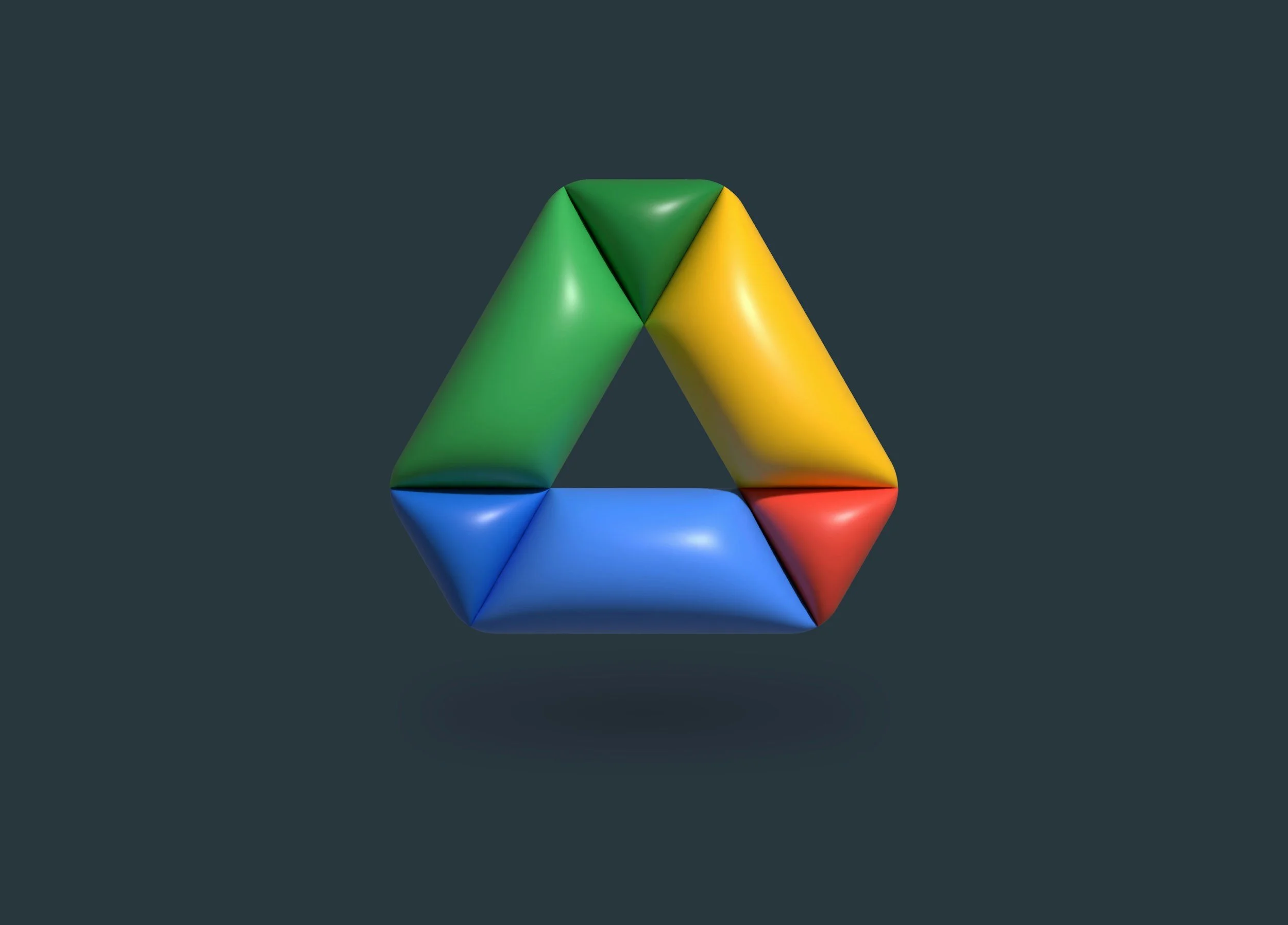 Colorful geometric shape composed of interconnected triangular and pyramid-like segments in green, yellow, blue, and red, floating against a dark background.