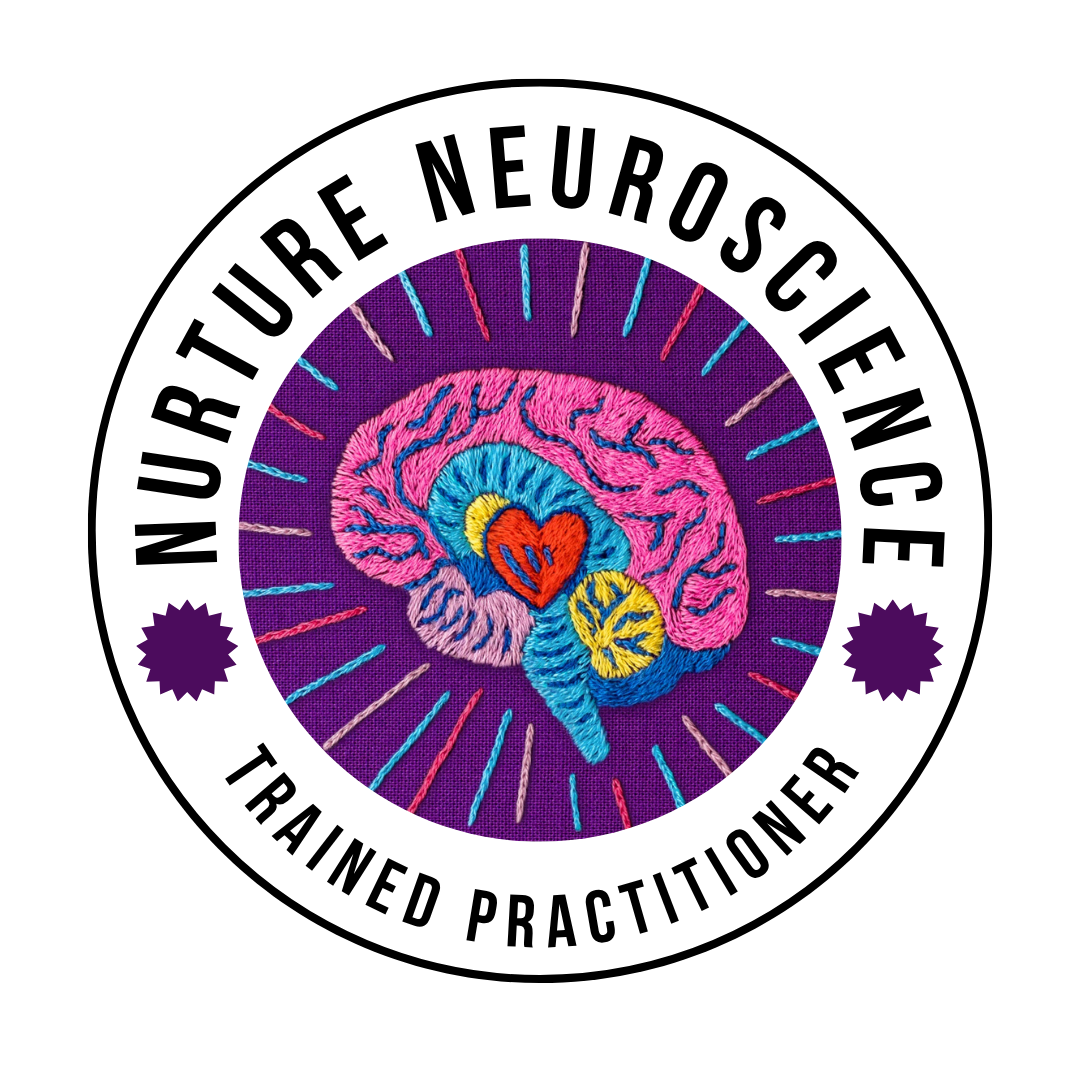 Colorful embroidered patch featuring a pink brain with a central heart, surrounded by radiating lines on a purple background.
