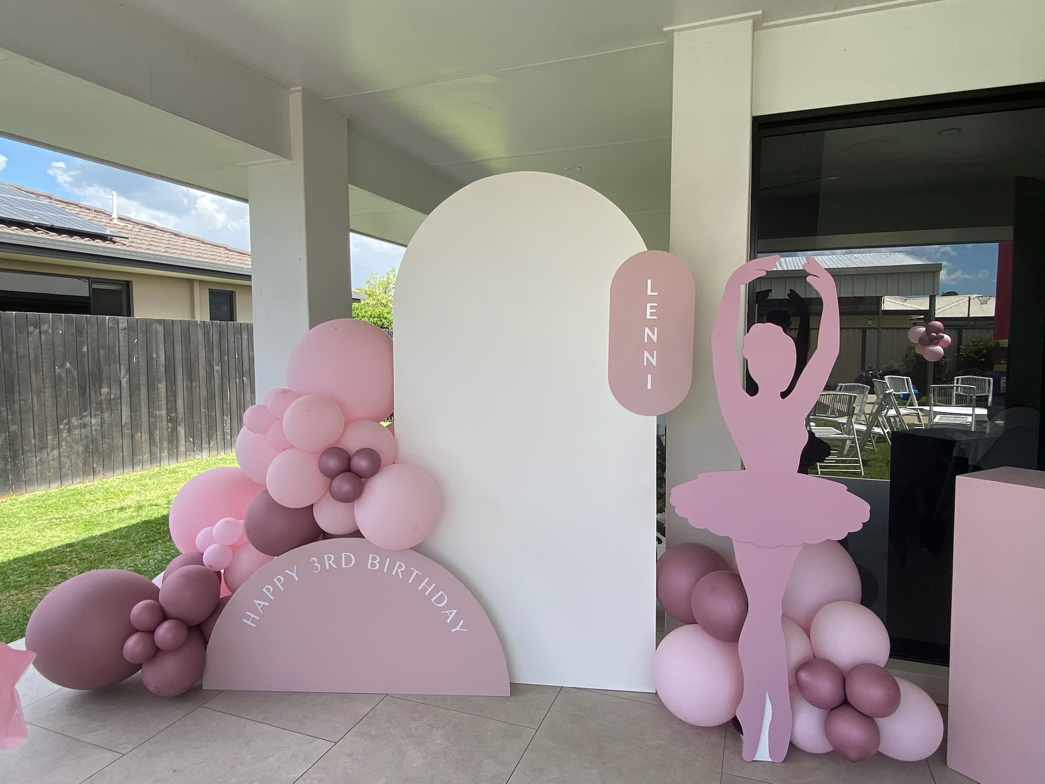 Ballet-themed birthday decoration with pink and purple balloons, a ballet dancer cutout, and a sign that says 'Happy 3rd Birthday' for Lennie.