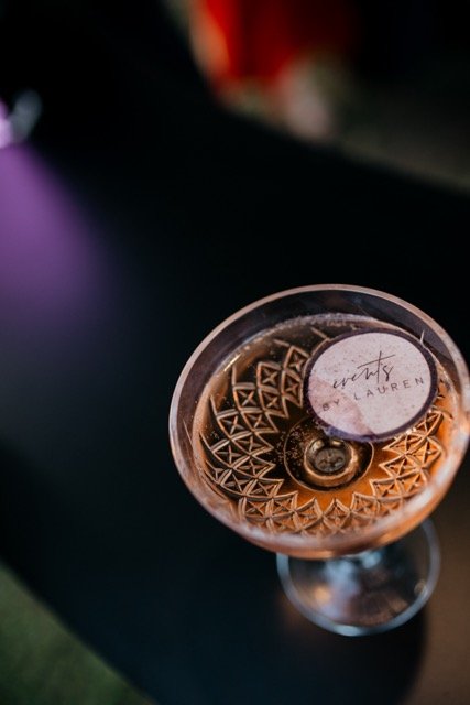 Glass of rosé wine on a table with a label that says 'Wit’s Laren'.