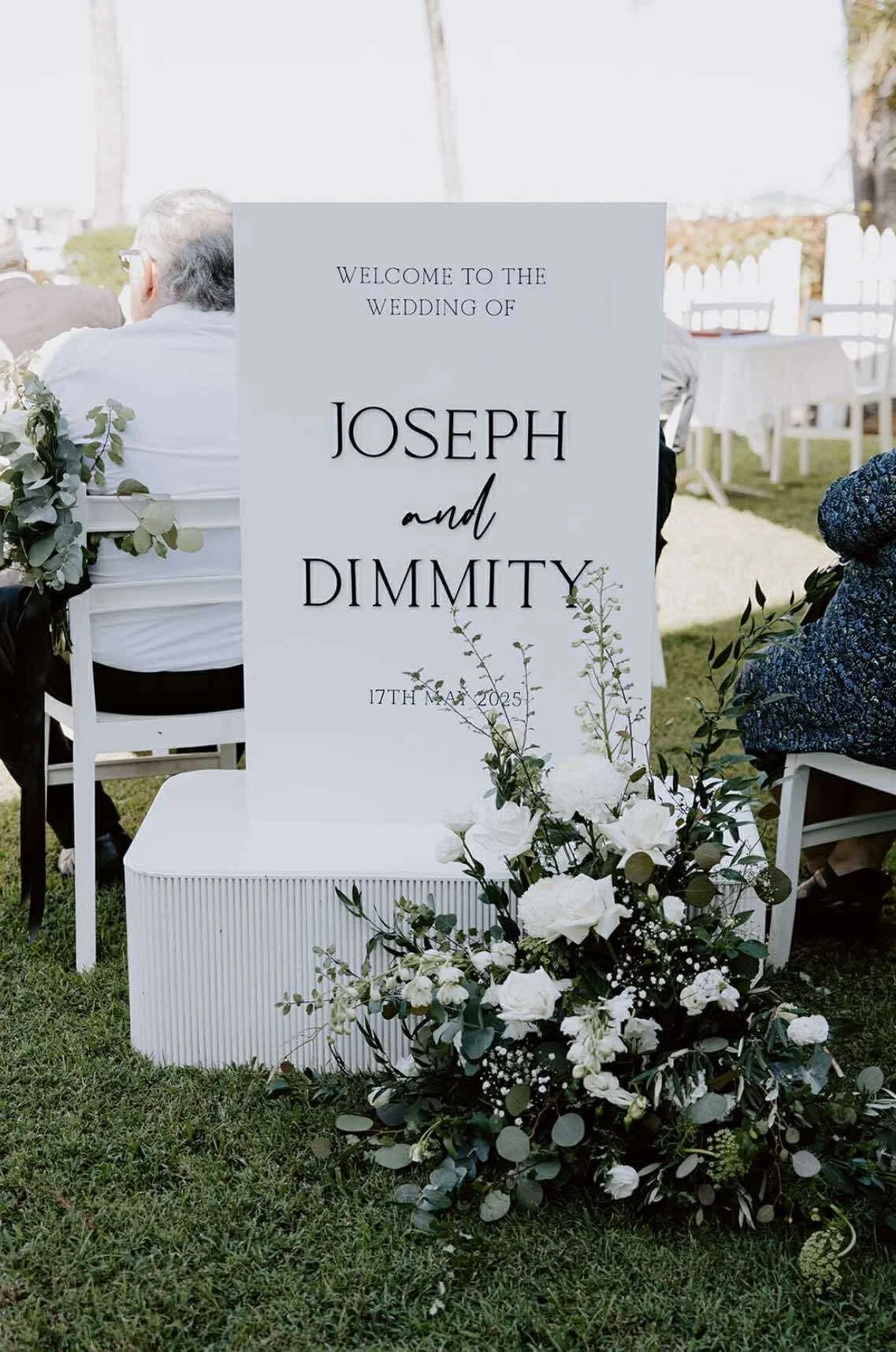 Wedding sign welcoming guests to the wedding of Joseph and Dimmik at an outdoor venue.
