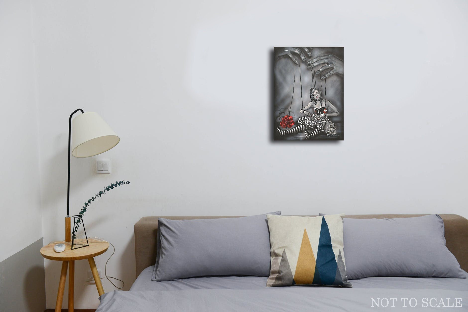 Marionette Woman Tied With Strings manipulated by hands above. Black and gray art print with one red flower lying on the ground and a skull. Hanging on wall.